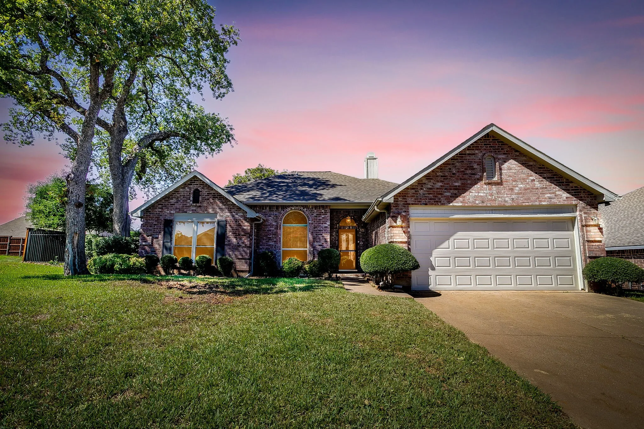Brick exterior with an attached two-car garage