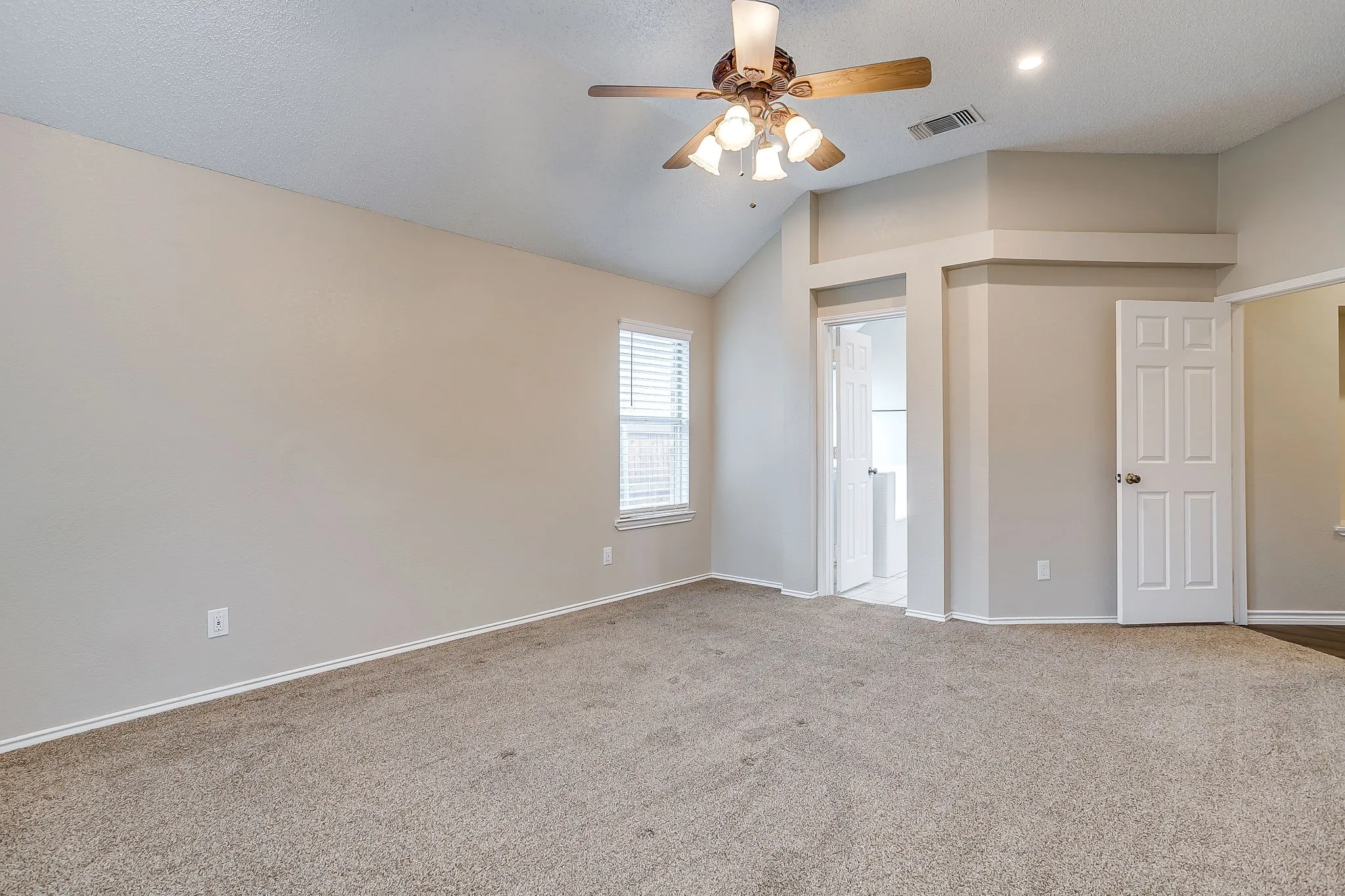 Vaulted ceiling with a ceiling fan, recessed lighting, carpet flooring, window with blinds, and paneled doors