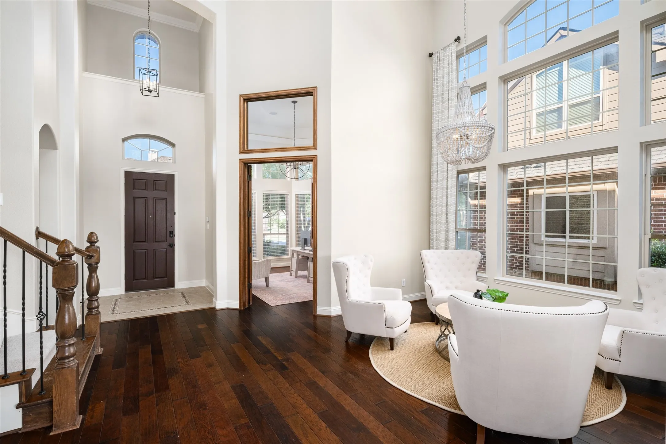 Two-story entry with dark wood-finish flooring