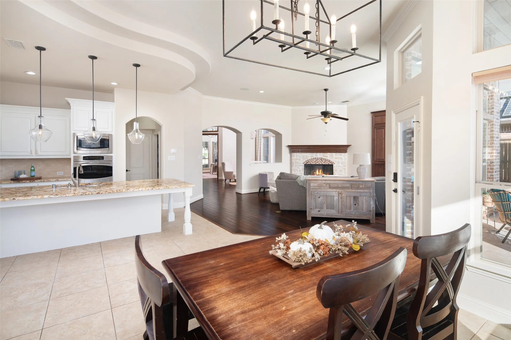 Kitchen featuring white cabinetry, stainless steel appliances, granite countertops, and pendant lighting