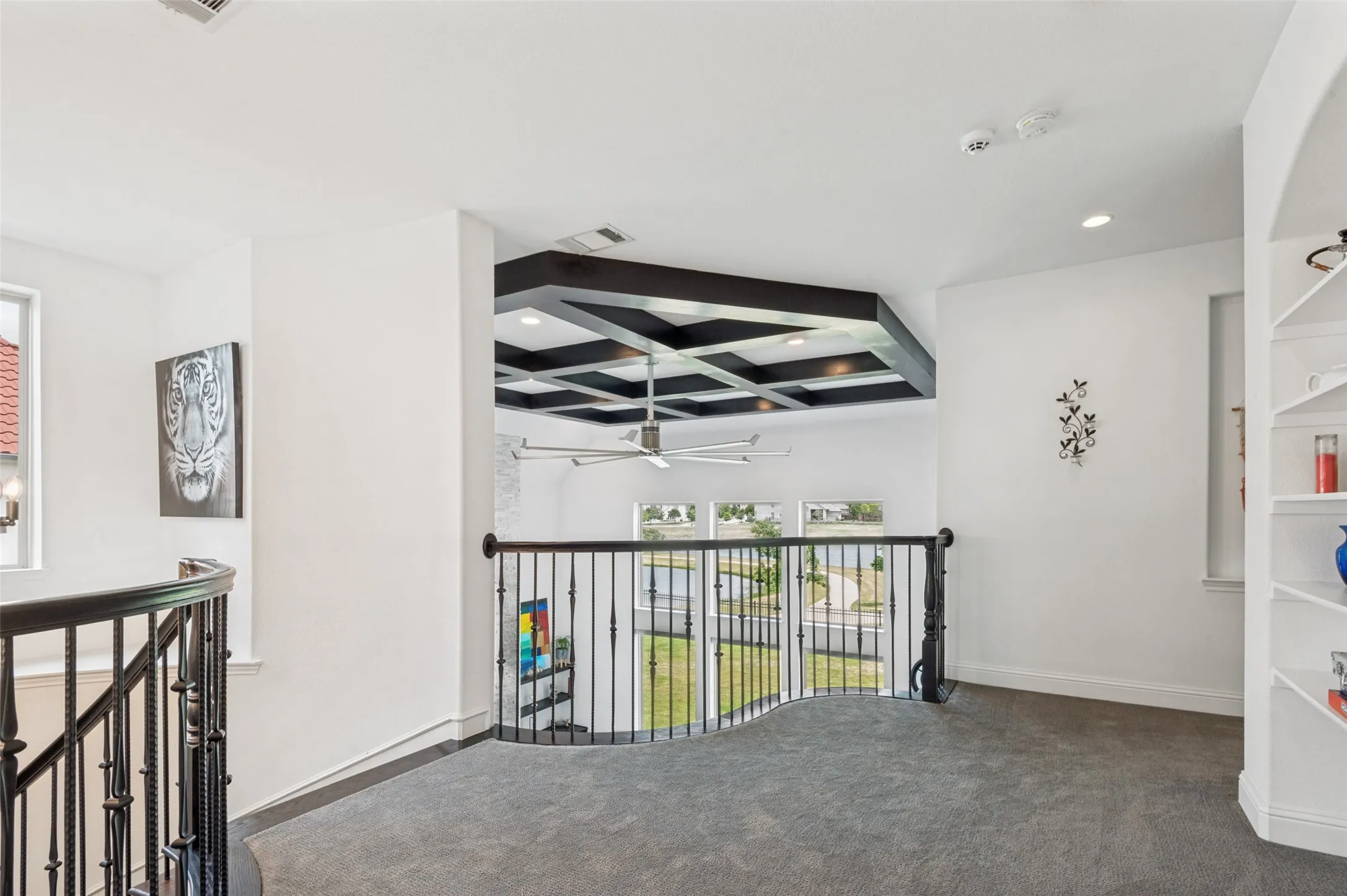 Beamed ceiling going up curved staircase