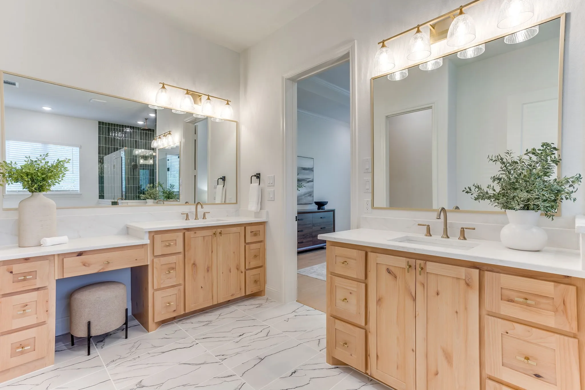 Dual vanity with wood-finish cabinetry, Quartz countertops, and make up area.