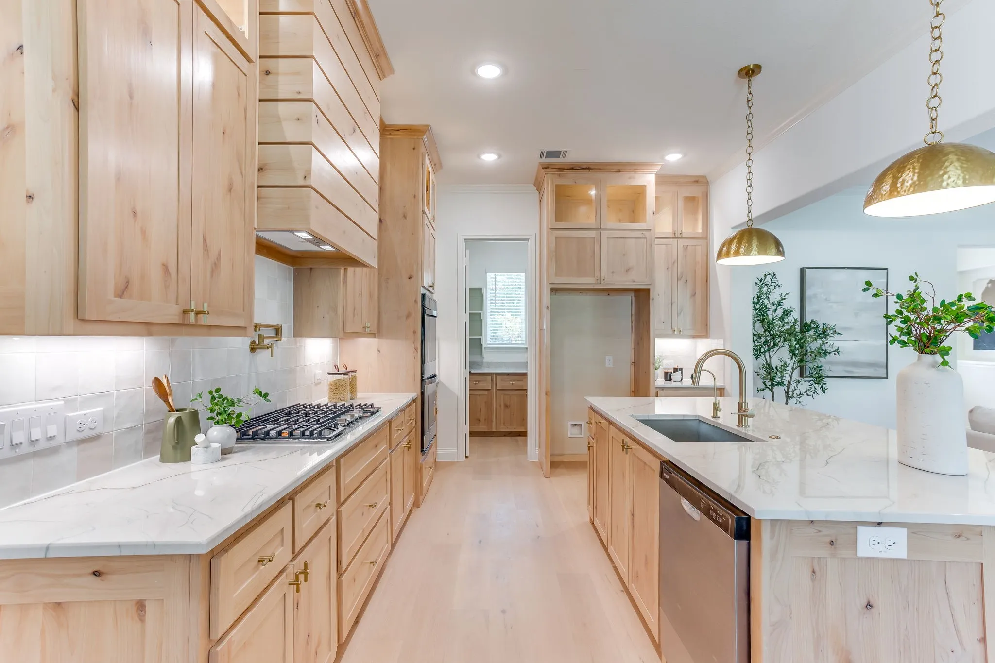 Kitchen with Quartzite countertops, 36" gas cooktop, plumbed for gas-propane, custom cabinetry to the ceiling and a butler pantry