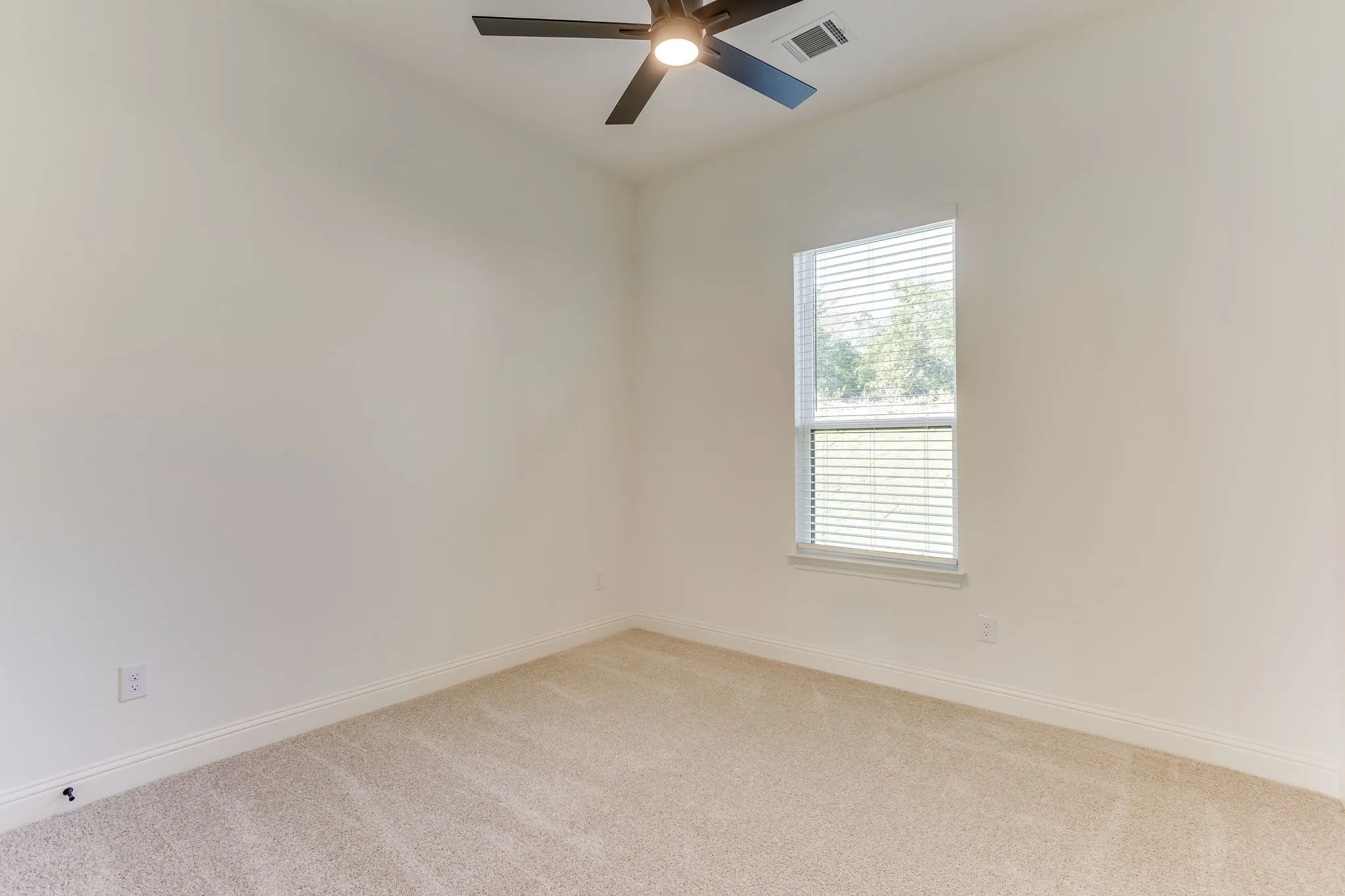 Bedroom with ceiling fan and walk in closet