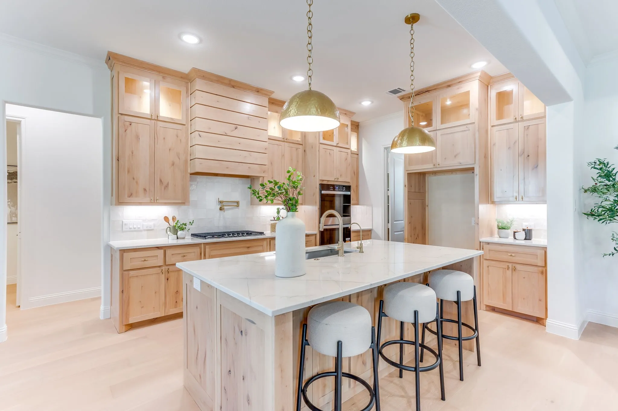 Kitchen with Quartzite countertops, 36" gas cooktop, plumbed for gas-propane, custom cabinetry to the ceiling and a butler pantry