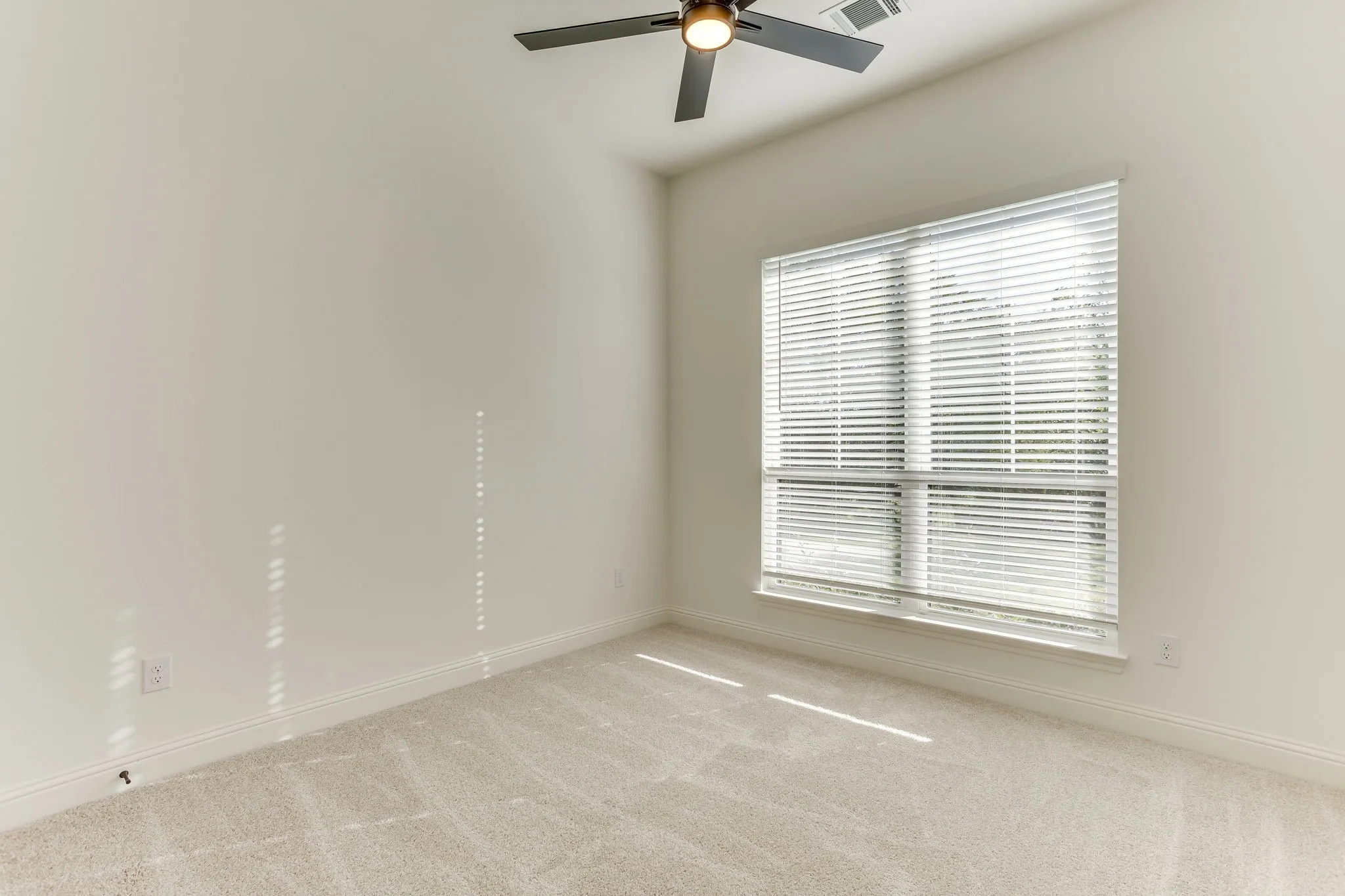Bedroom with ceiling fan and walk in closet