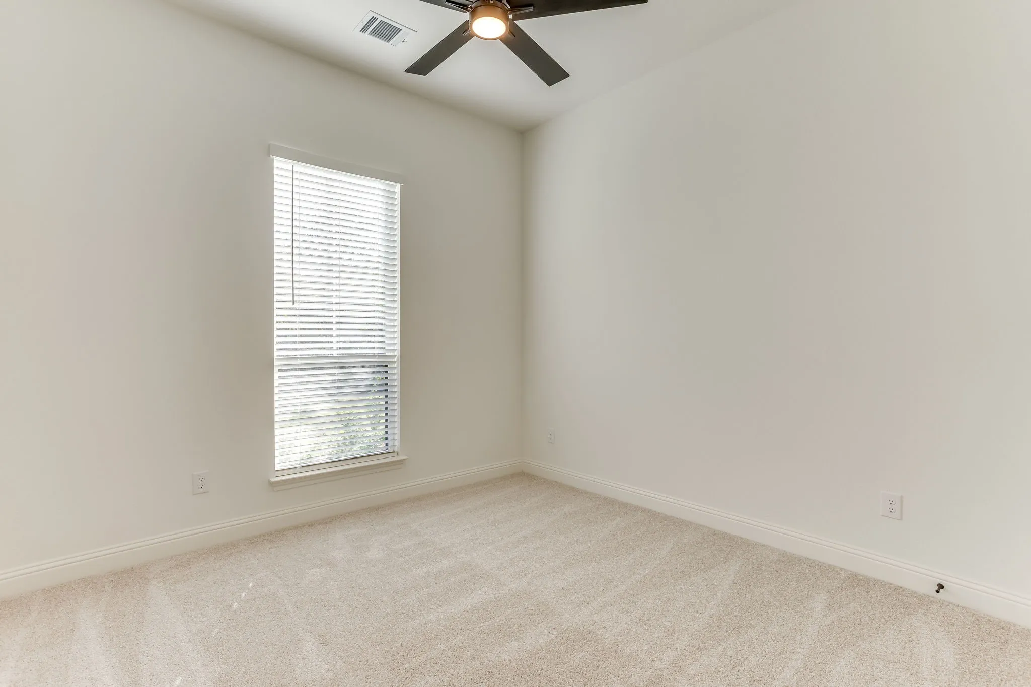 Bedroom with ceiling fan and walk in closet