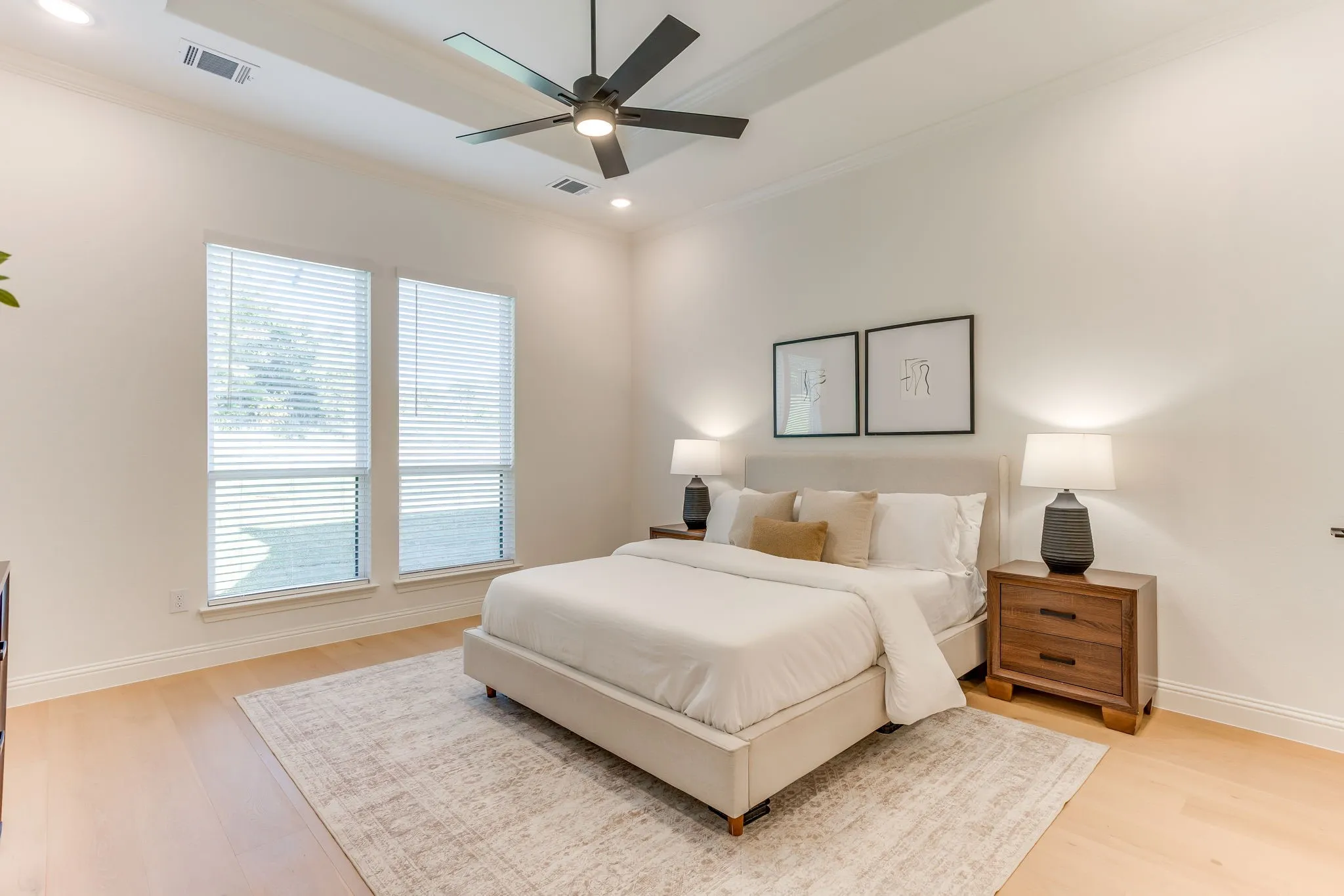 Tray ceiling, recessed lighting, wood  flooring, large windows with a view to the treed backyard