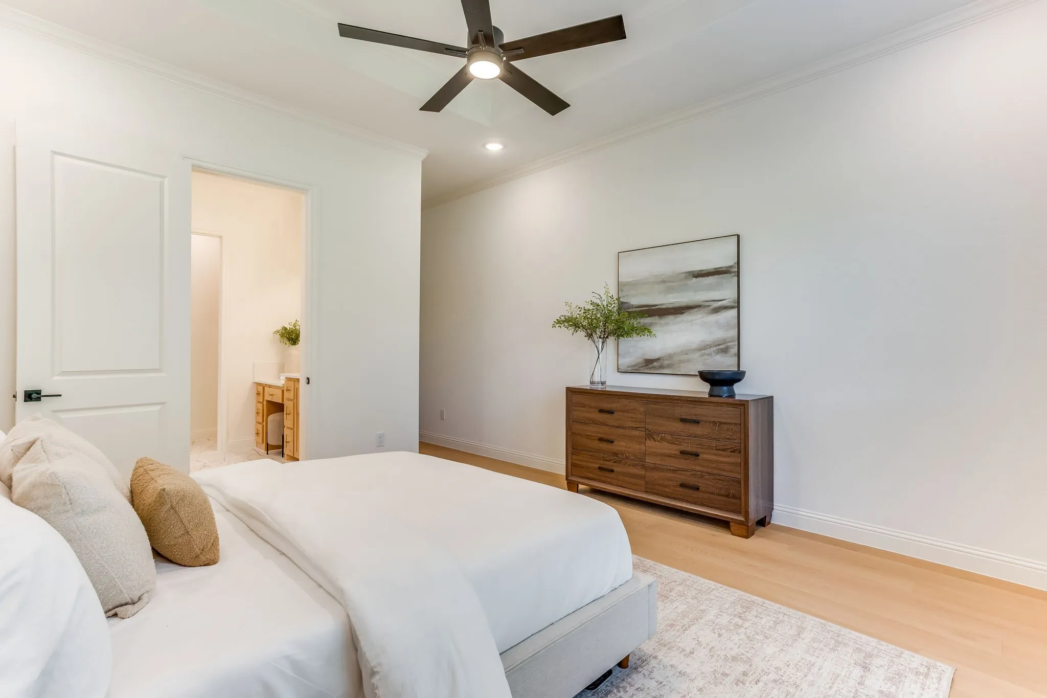 Tray ceiling, recessed lighting, wood  flooring, large windows with a view to the treed backyard