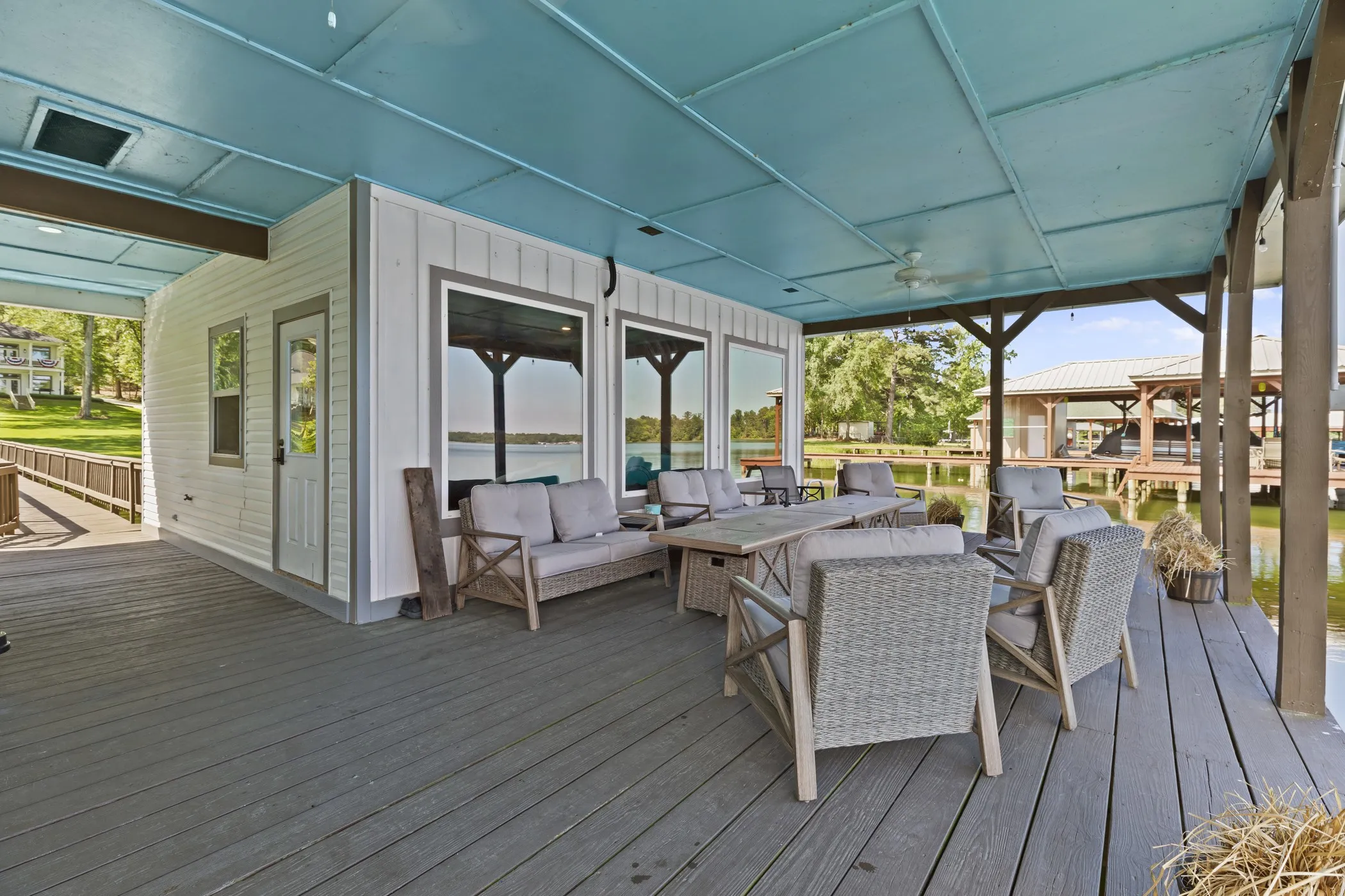 Expansive outdoor deck with gray composite decking and a light blue paneled ceiling