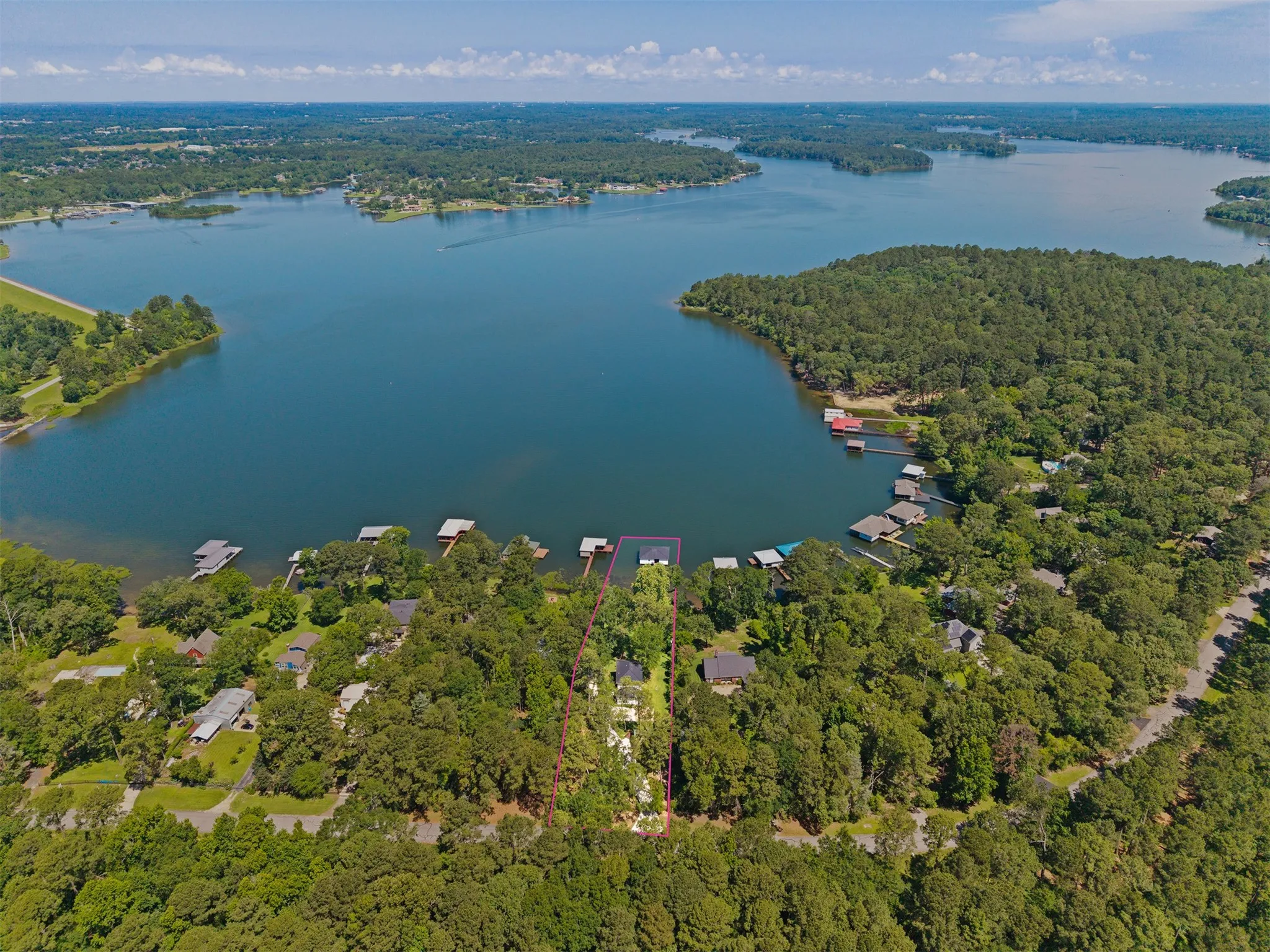 Expansive waterfront property featuring mature trees and direct lake access