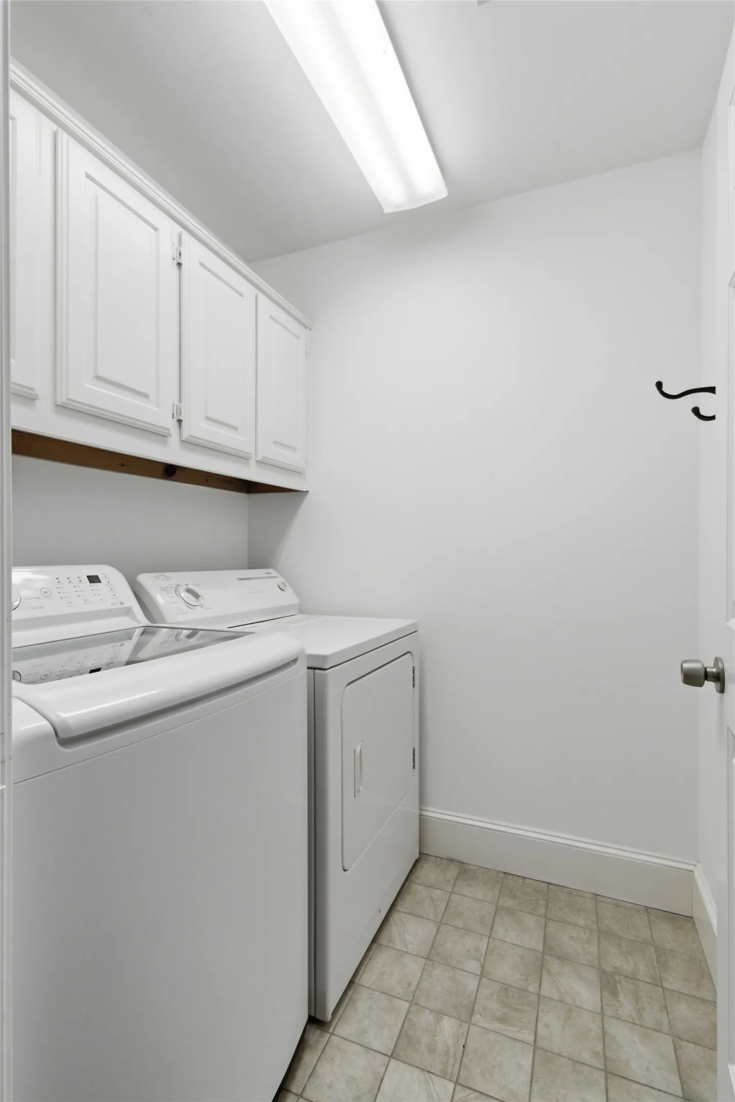 Separate laundry room for full size washer/dryer and cabinetry.
