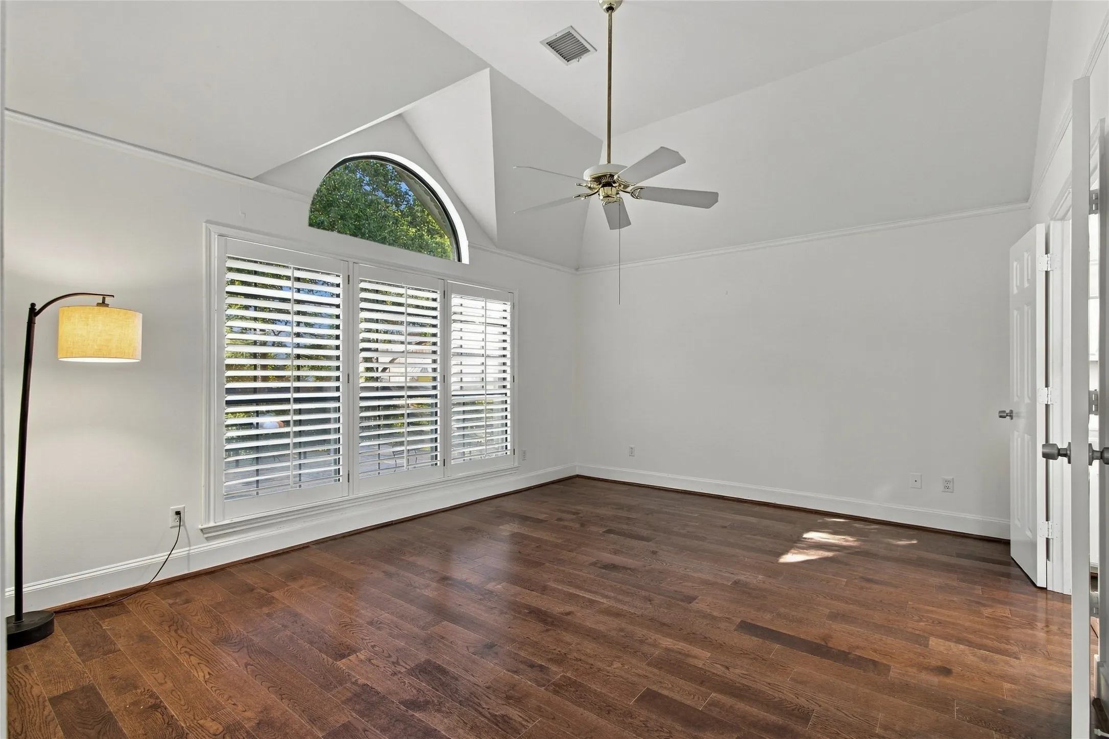 Spacious primary bedroom-split from secondary bedrooms. Wood floors, plantation shutters and vaulted ceiling!