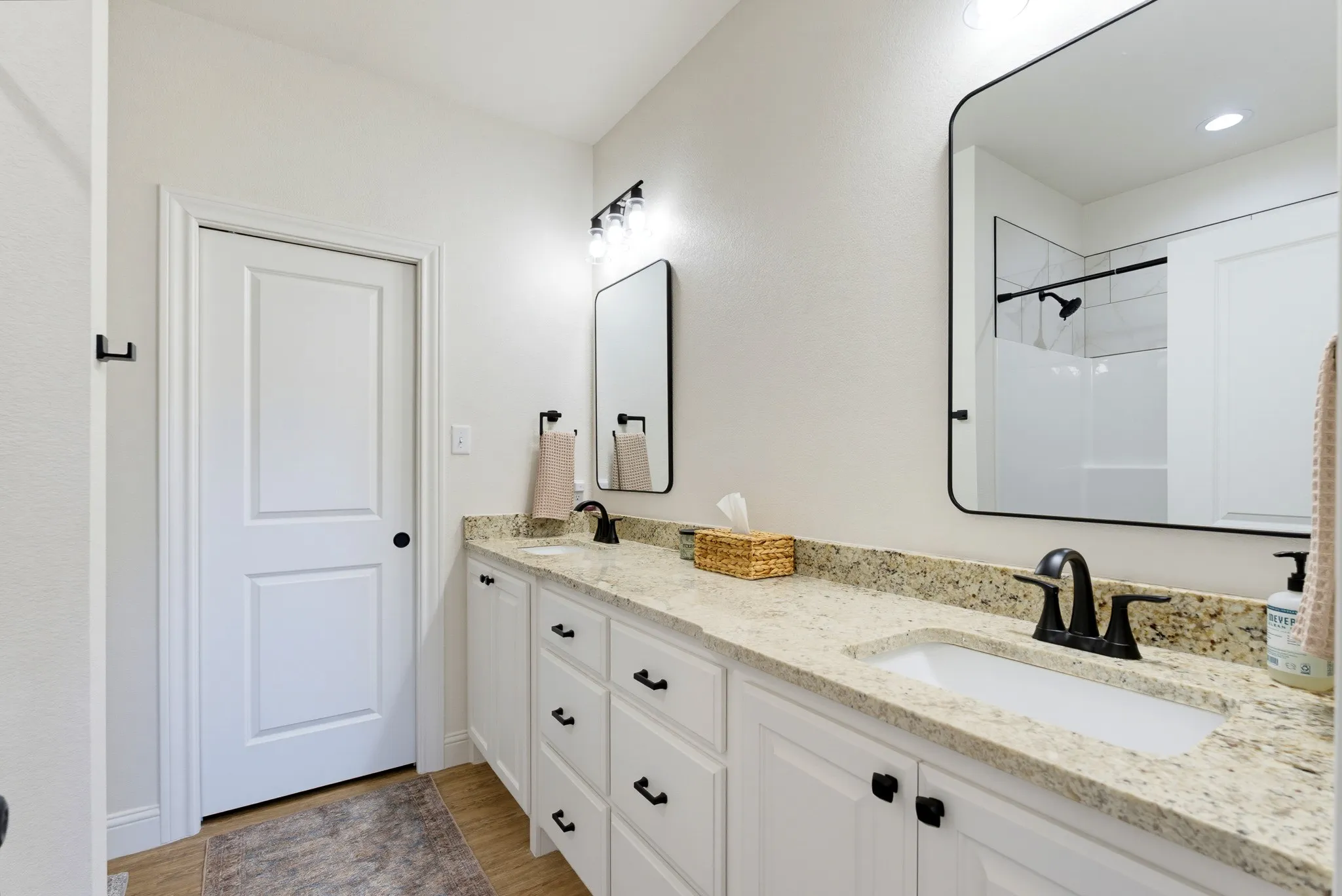 Dual vanity with stone-finish countertops and integrated sinks