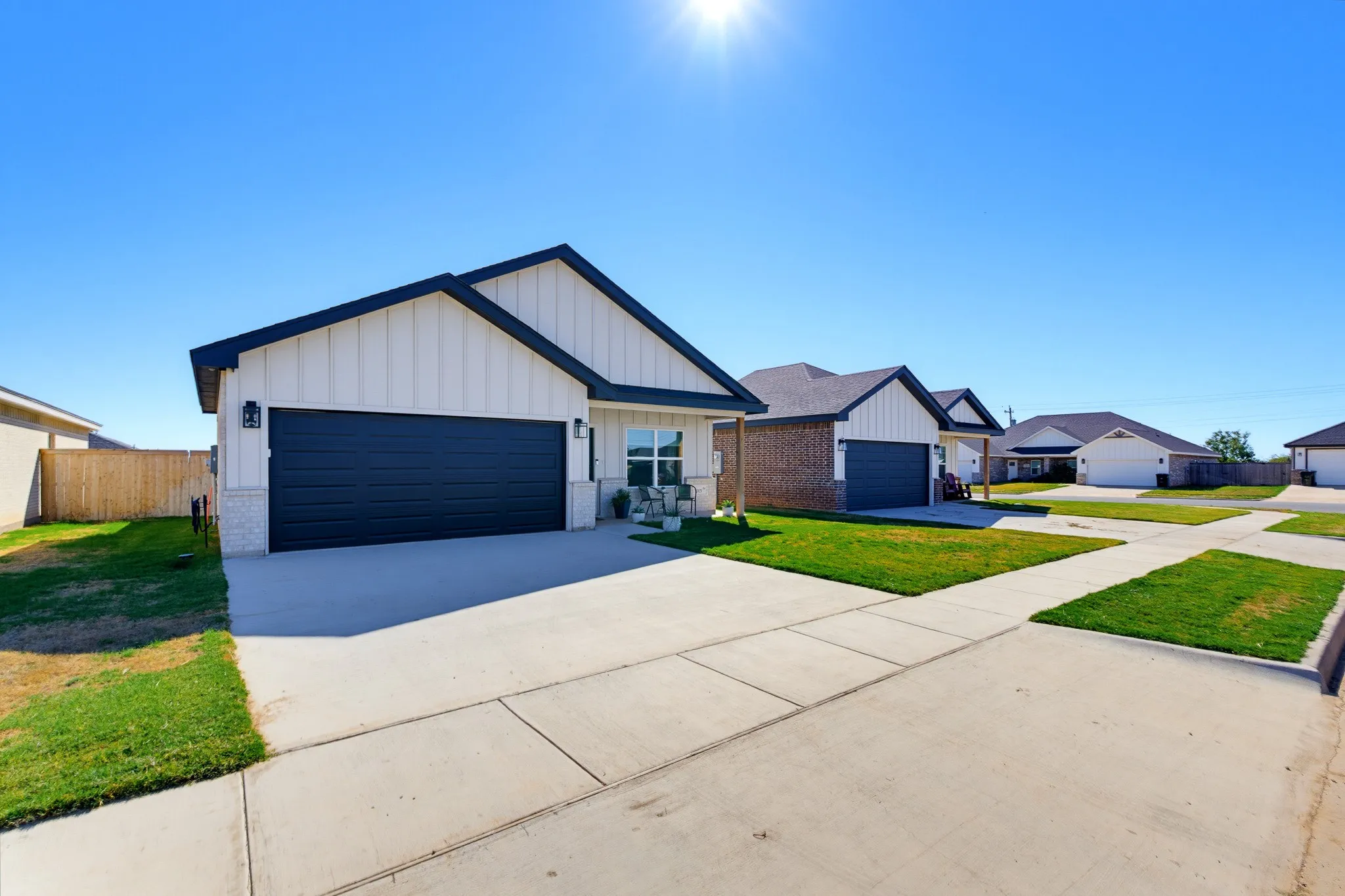 Contemporary exterior featuring vertical siding and dark trim