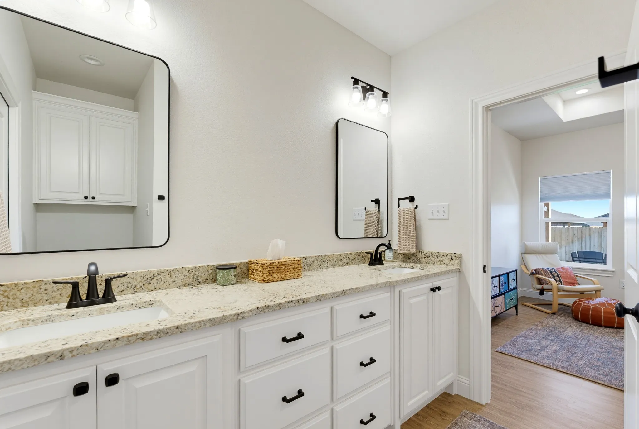 Dual vanities with stone countertops and undermount sinks