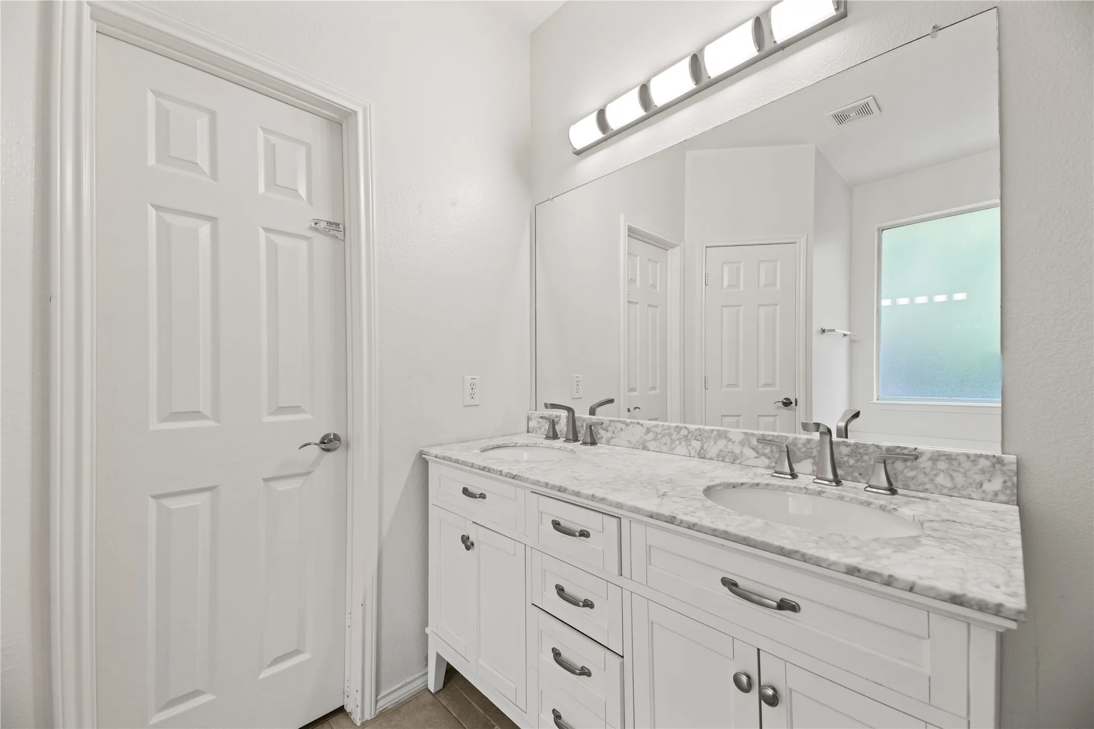 Dual vanity with undermount sinks and chrome fixtures
