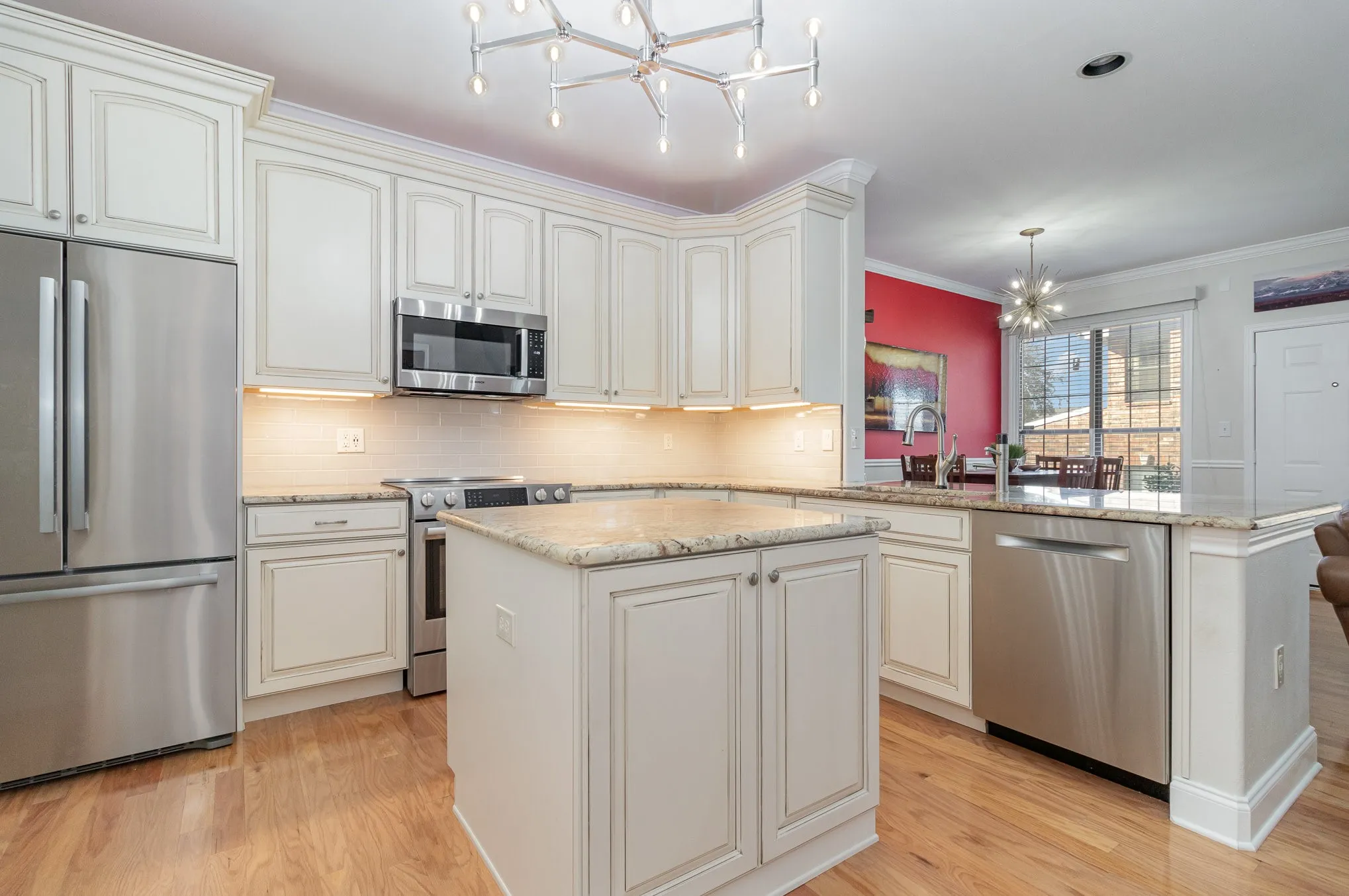 Kitchen has central island (with power), custom light fixture, recessed LED lighting, 42" cabinets, granite counters.
