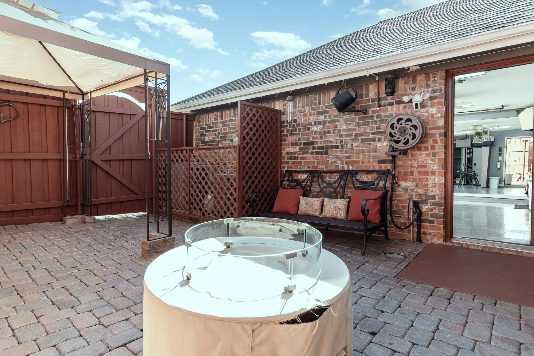 Awning section of side yard patio area. Lattice fencing shields the two over-capacity HVAC units.