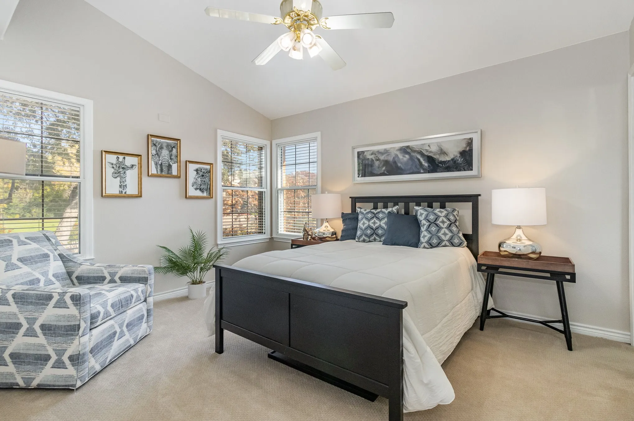 Secondary bedroom upstairs with elegant double-pane soundproof windows, electric shades, lighted ceiling fan, vaulted ceiling.
