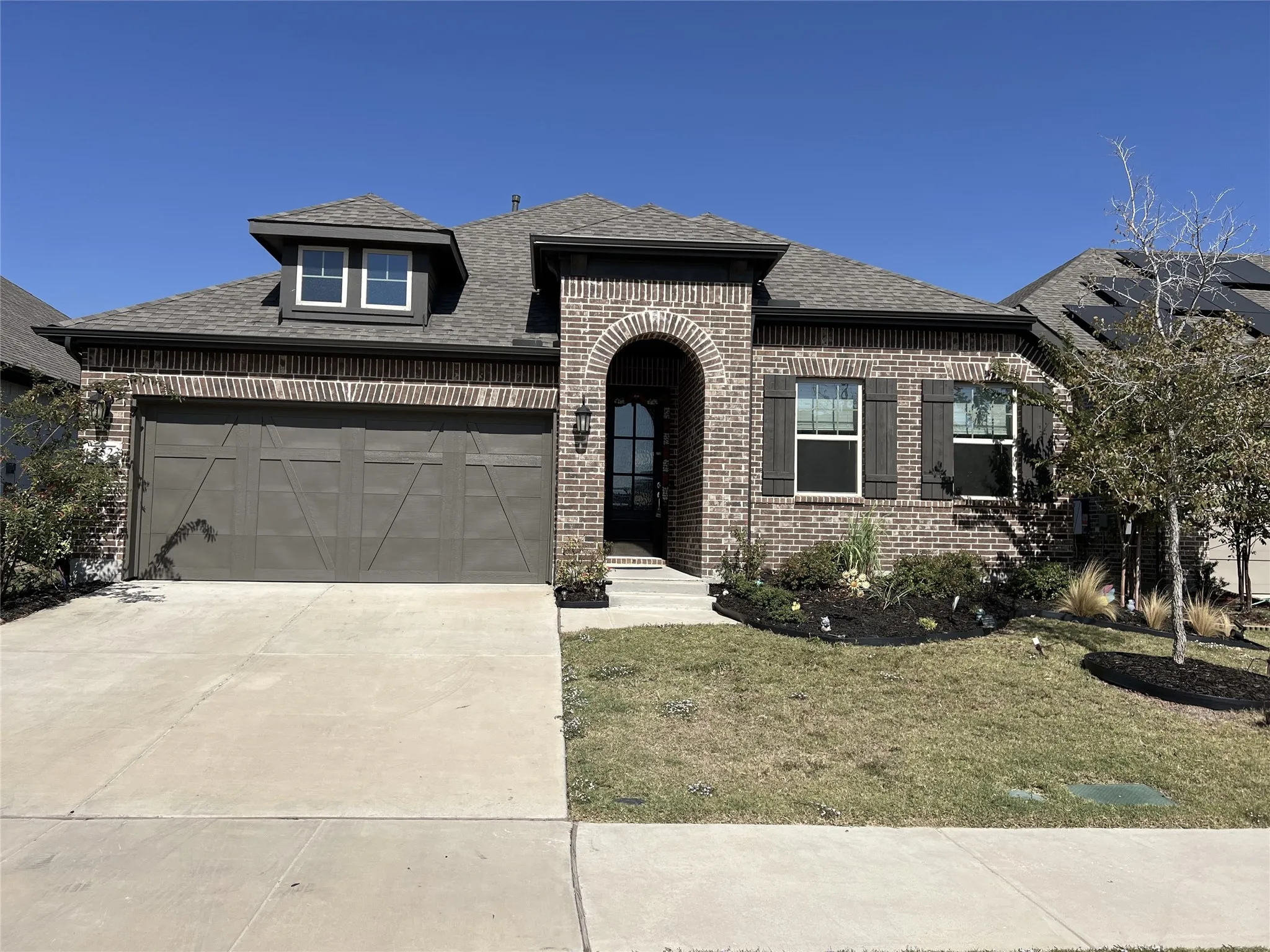 View of front facade with a garage and a front lawn