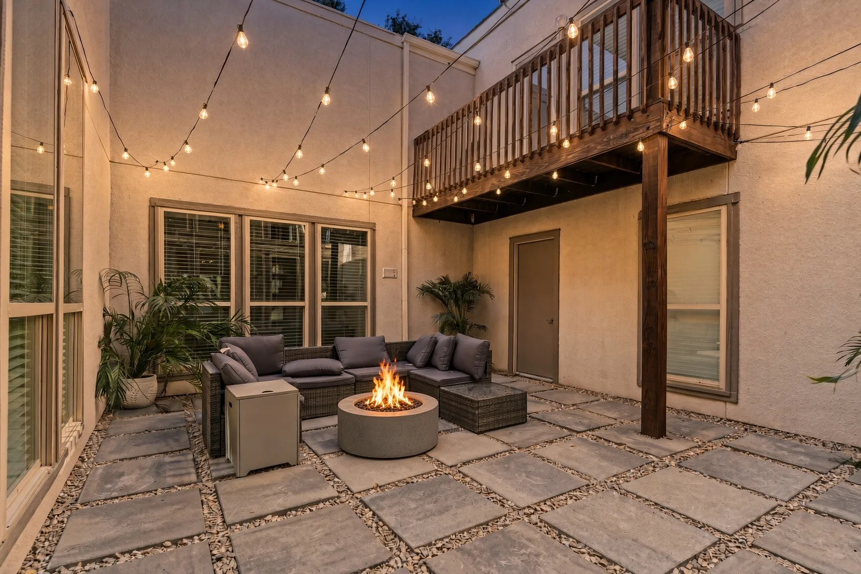 Night View of Private Courtyard featuring large format pavers, and exterior string lighting