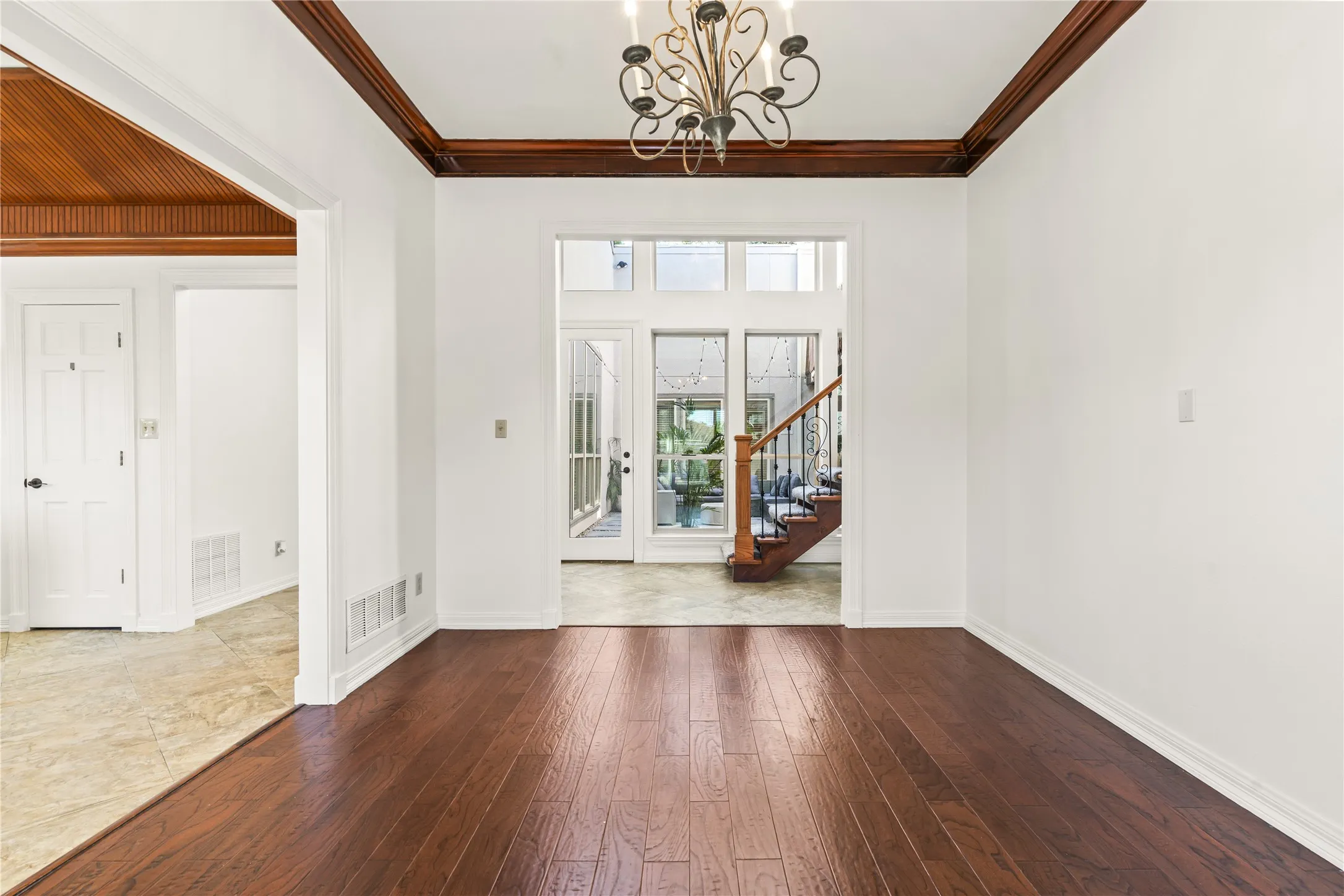 Dark wood-finish flooring with white baseboards
