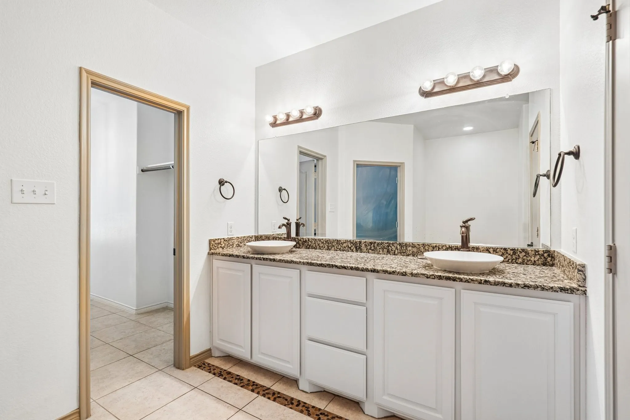 Dual vessel sinks set in a stone-finish countertop
