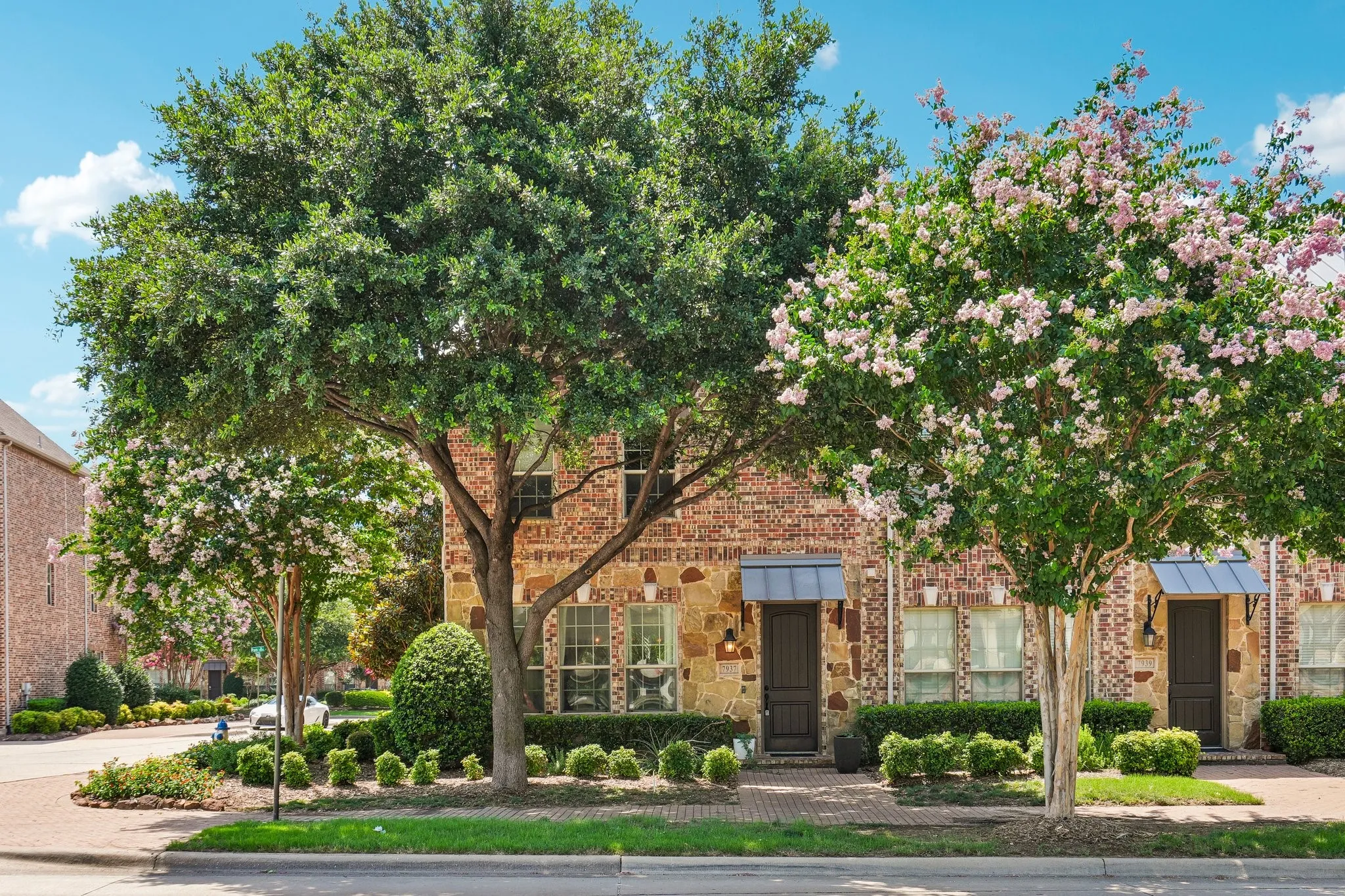 Brick and stone facade with decorative window awnings