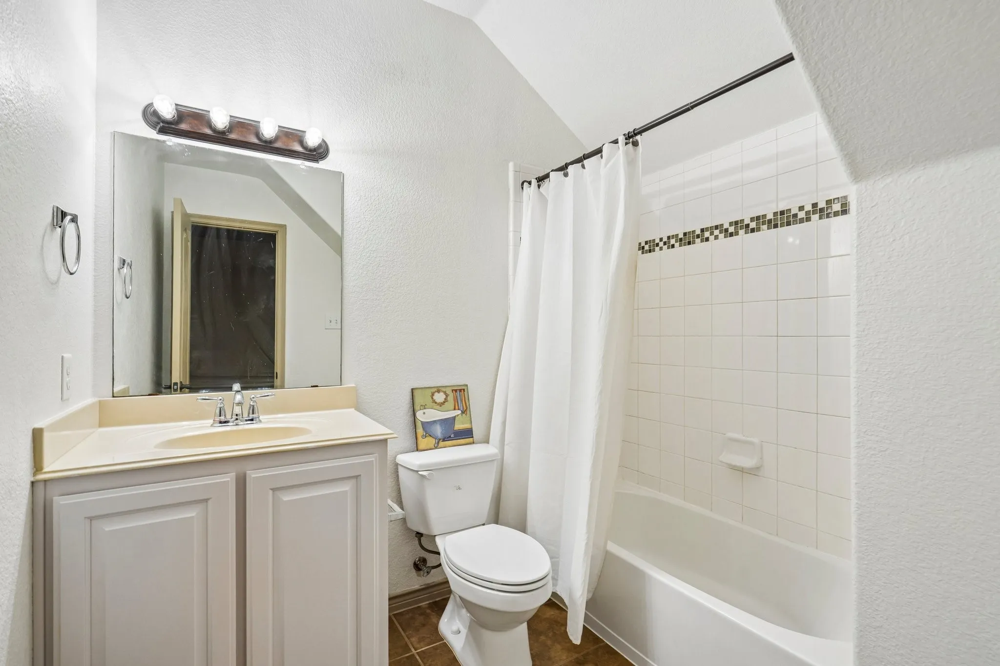 White tile shower with decorative accent border