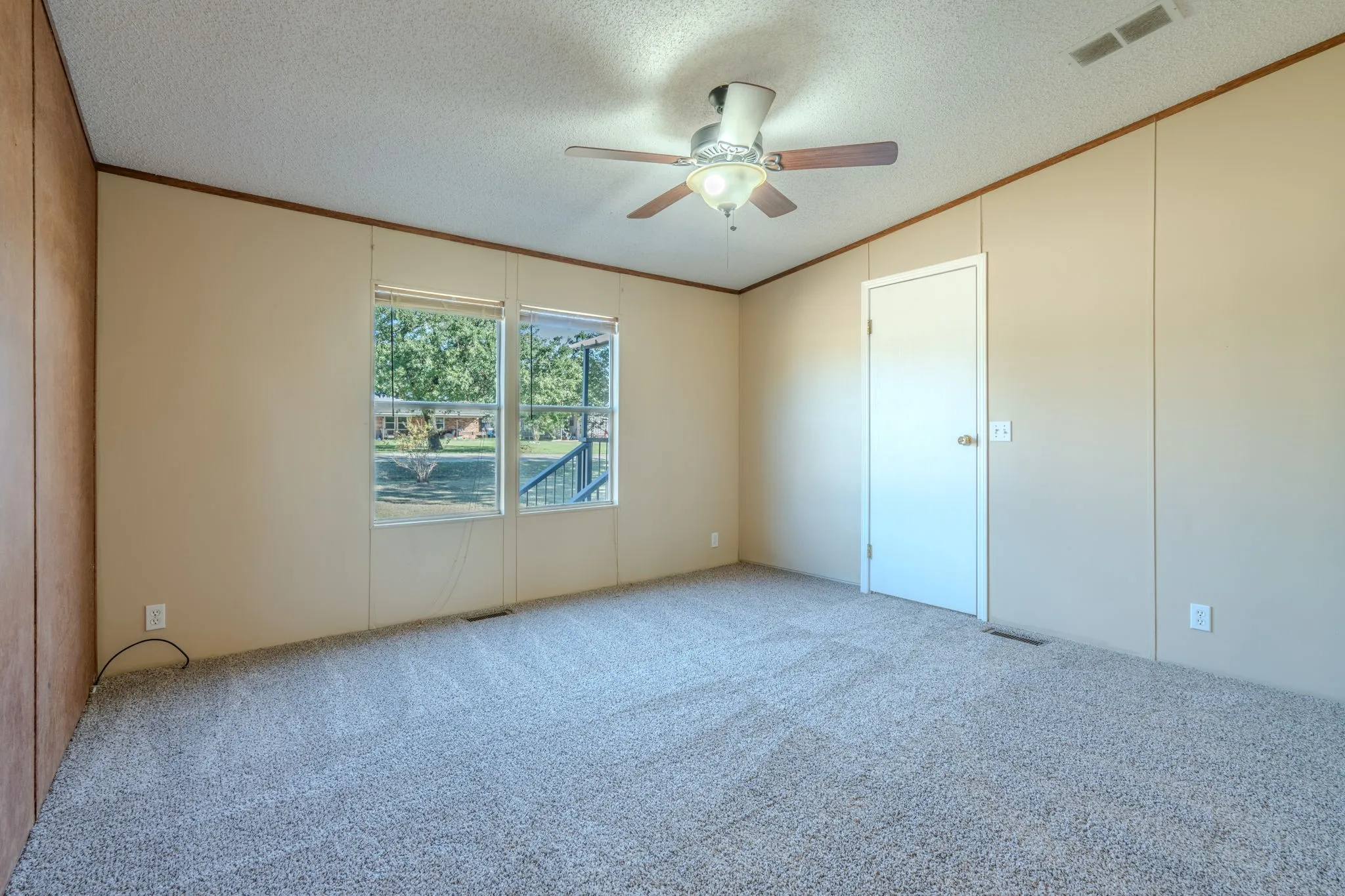 Bedroom: Alternate view highlighting the neutral wall finishes, ceiling fan, and enclosed closet.
Copy All 11 Captions