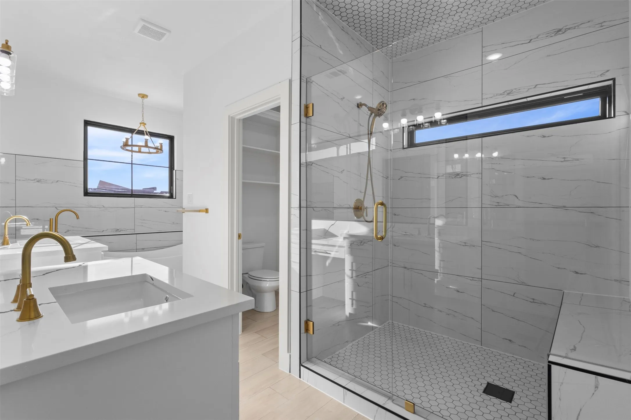 Dual vanities with integrated sinks and gold-finish fixtures