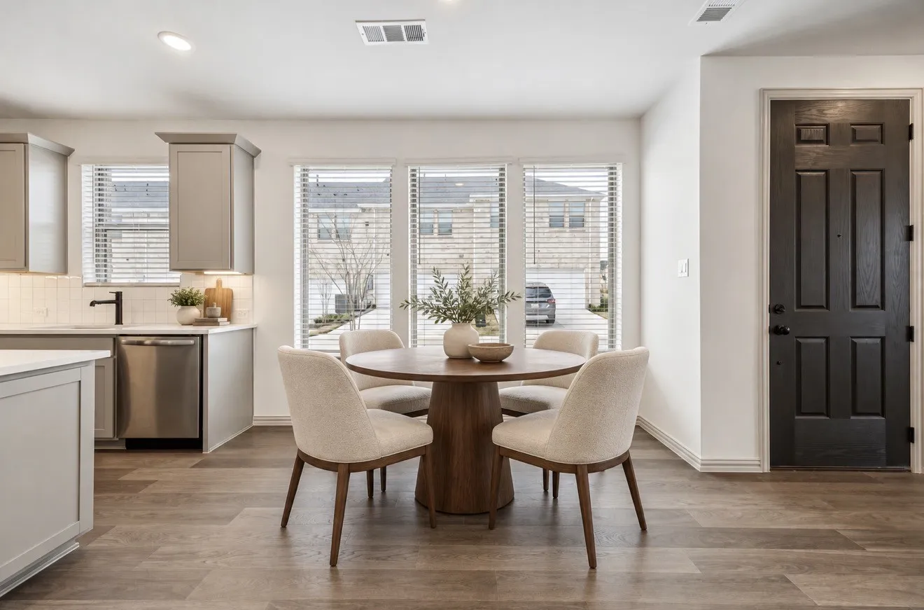 Virtually Staged. Open-concept living area featuring wood-finish flooring, recessed lighting, and a kitchen with light-toned cabinetry, stainless steel appliances, and a tile backsplash