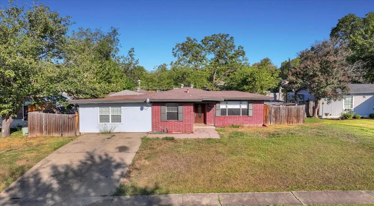 Brick and siding exterior with a single-car concrete driveway