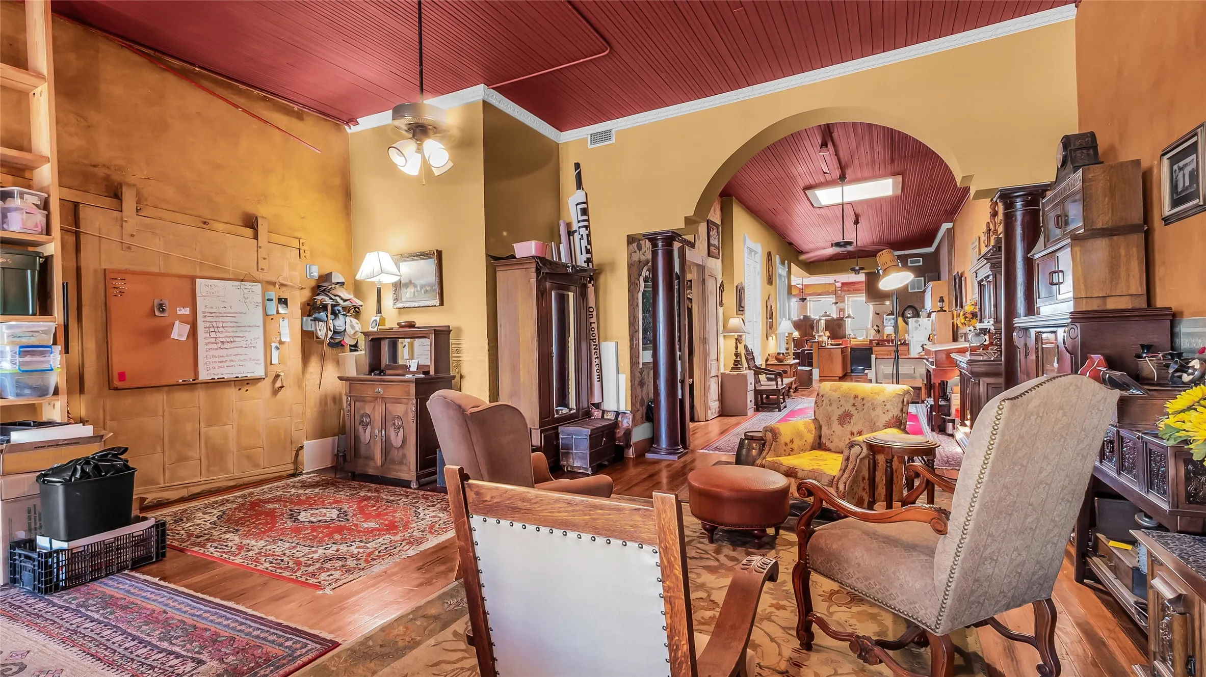 Open Loft with hardwood flooring and skylights