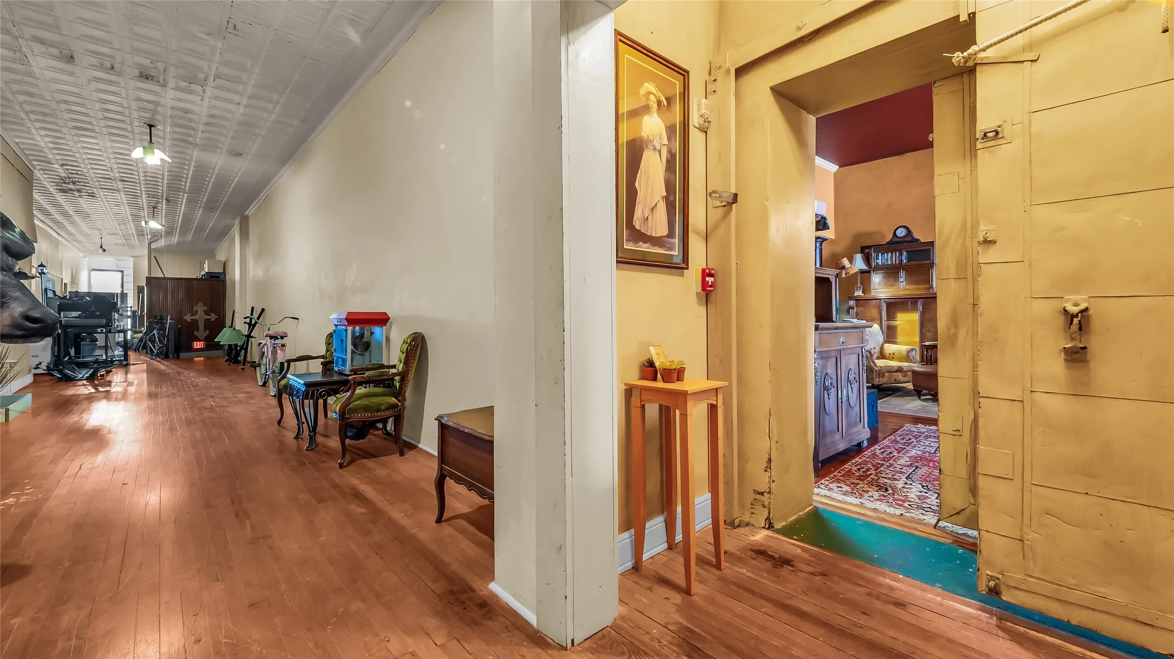 Hardwood flooring, painted walls, and a pressed tin ceiling