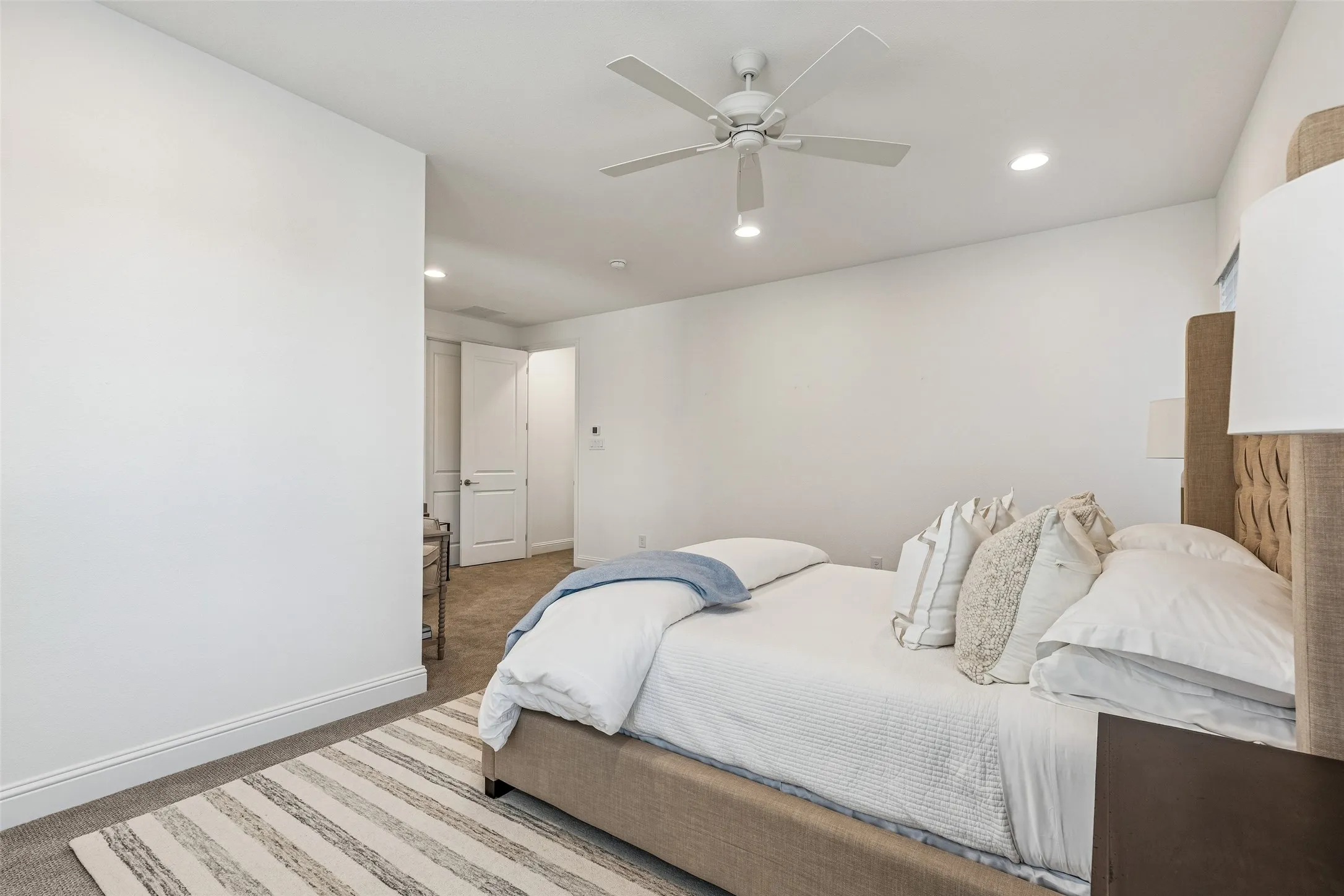 Recessed lighting, ceiling fan, carpeting, and white walls