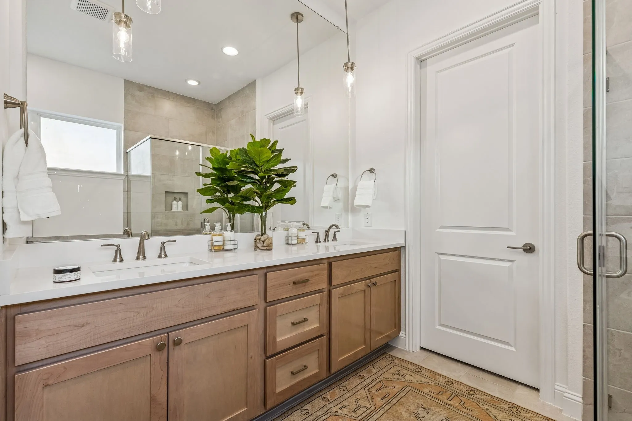 Dual vanity with undermount sinks and light wood-finish cabinetry