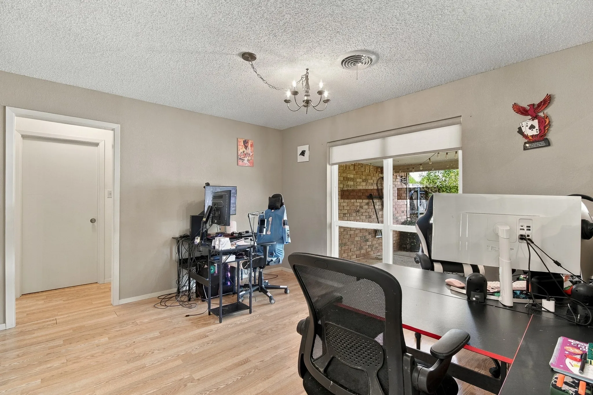 Wood-finish flooring, neutral wall paint, and a sliding glass door