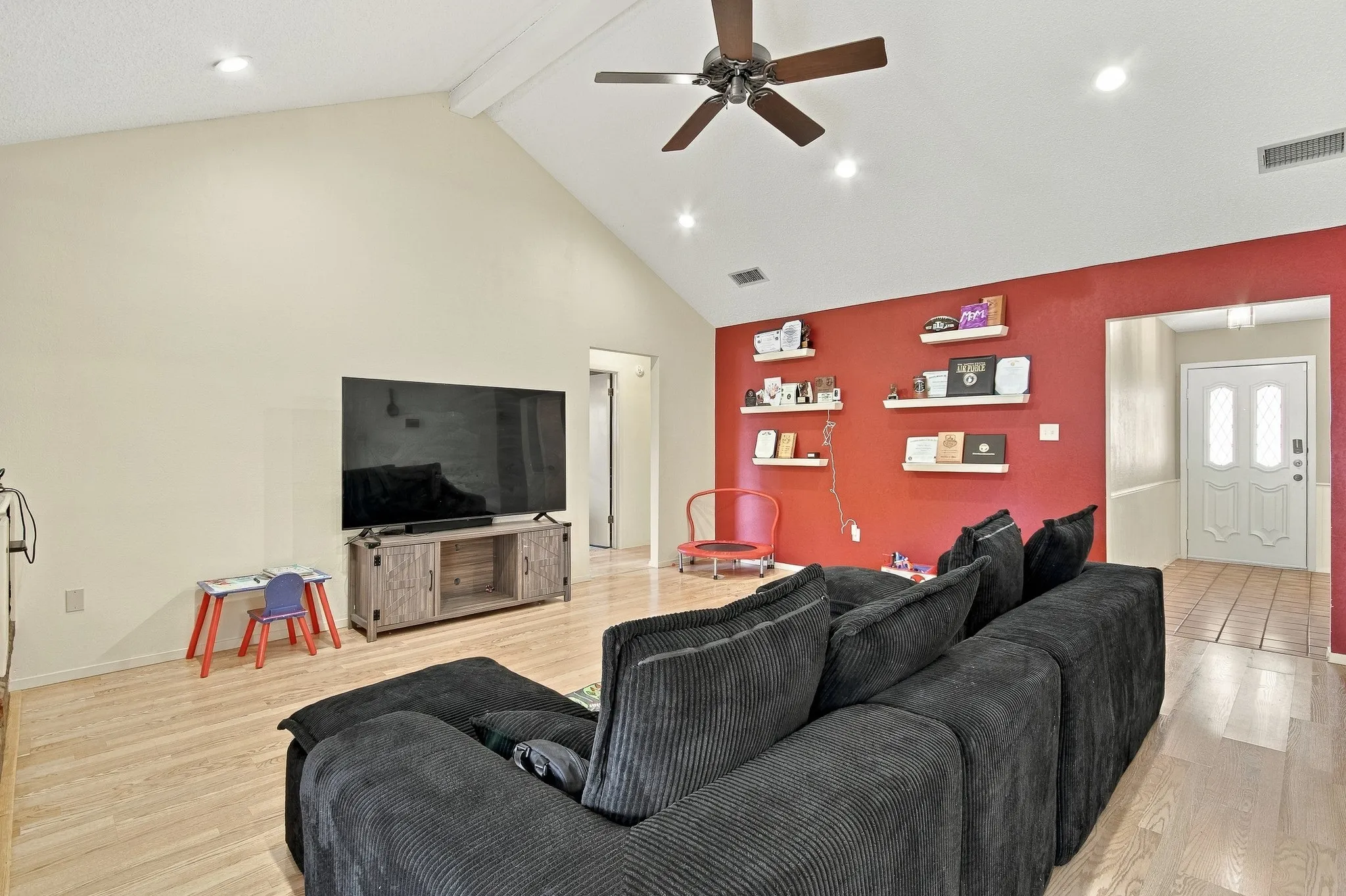 Vaulted ceilings with recessed lighting, wood-finish flooring, a ceiling fan, and an entry door with decorative glass inserts