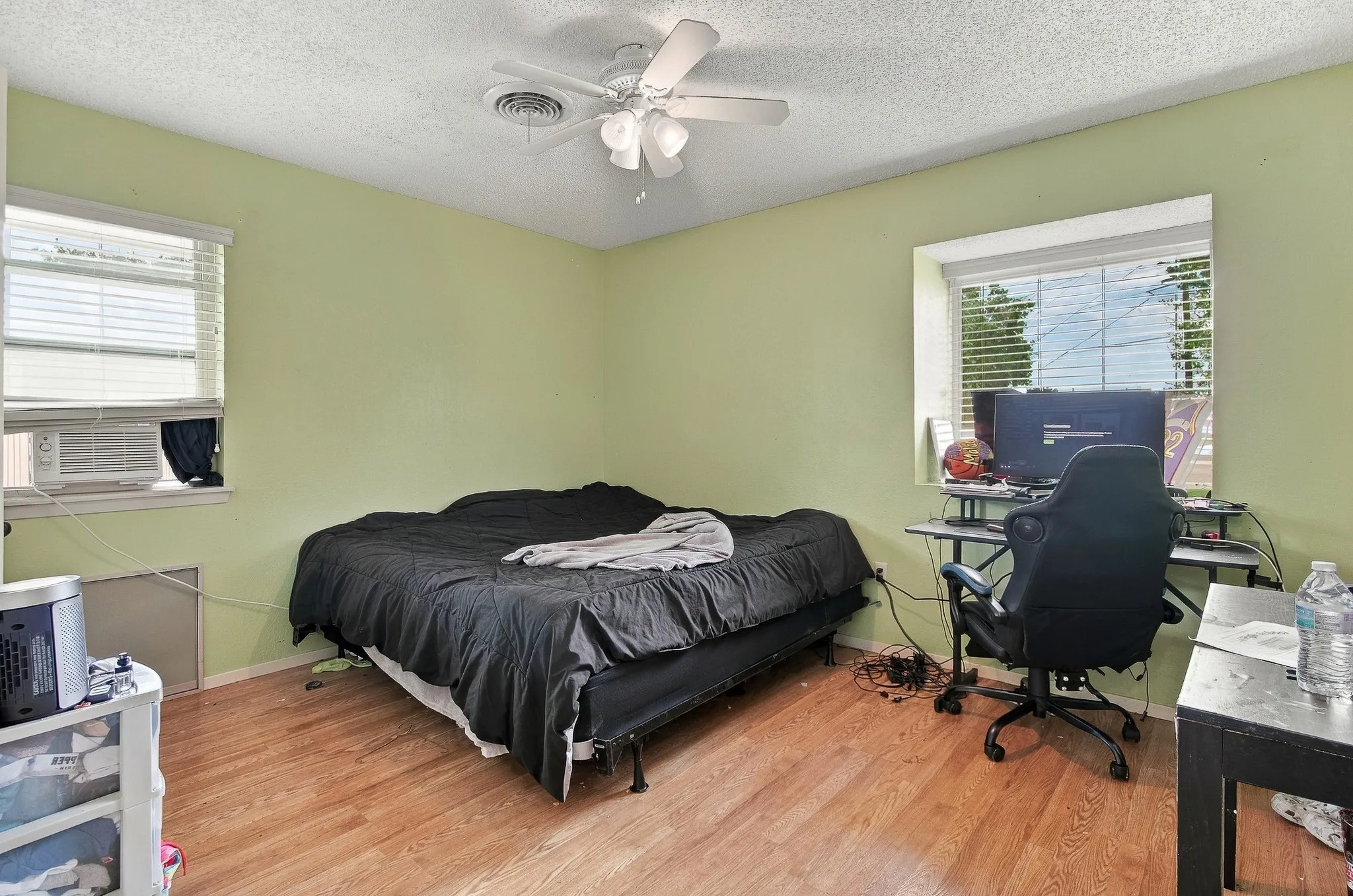 Wood-finish flooring with a ceiling fan light fixture
