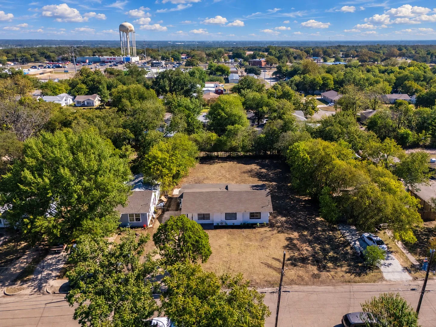 Expansive lot featuring mature trees and a residential street