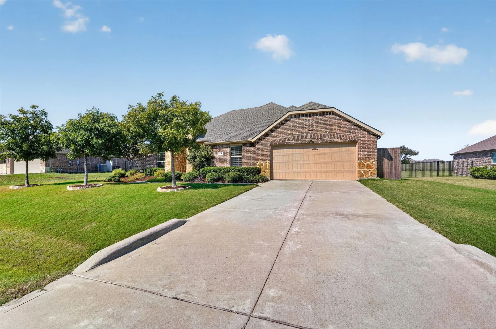 Brick and stone exterior with a two-car garage
