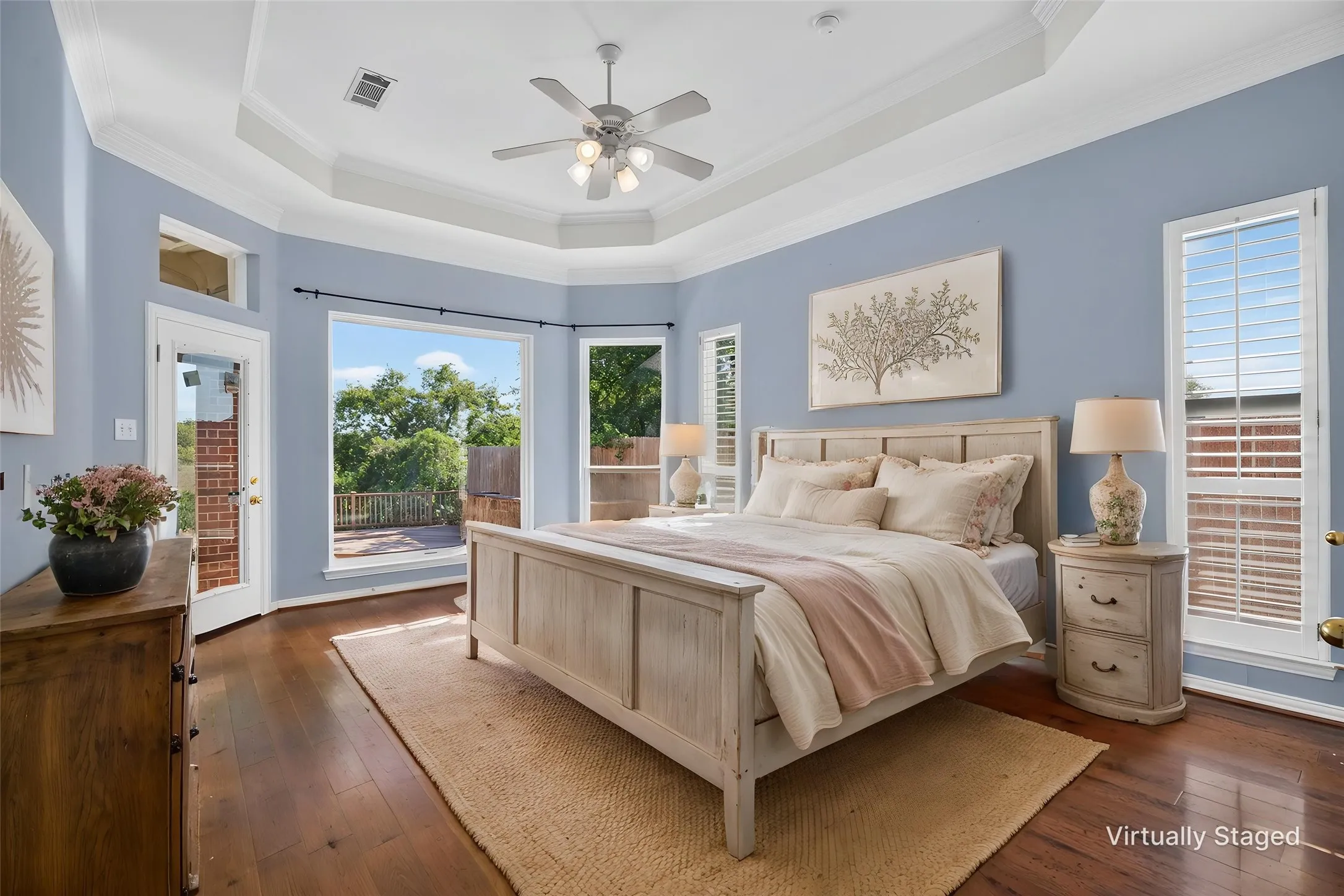 Natural lighting flows into this primary suite with spectacular views of the back open fields.