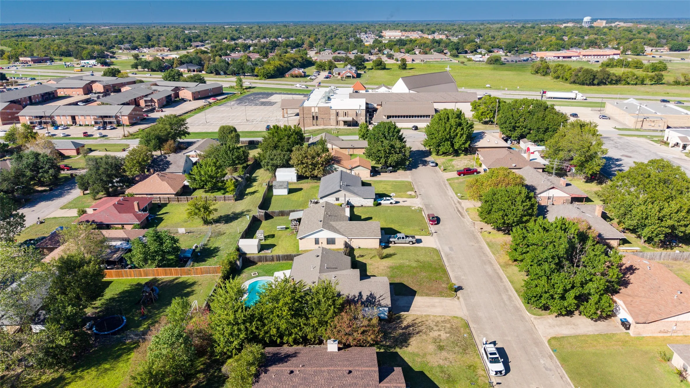 Expansive neighborhood setting with numerous mature trees and a residential street