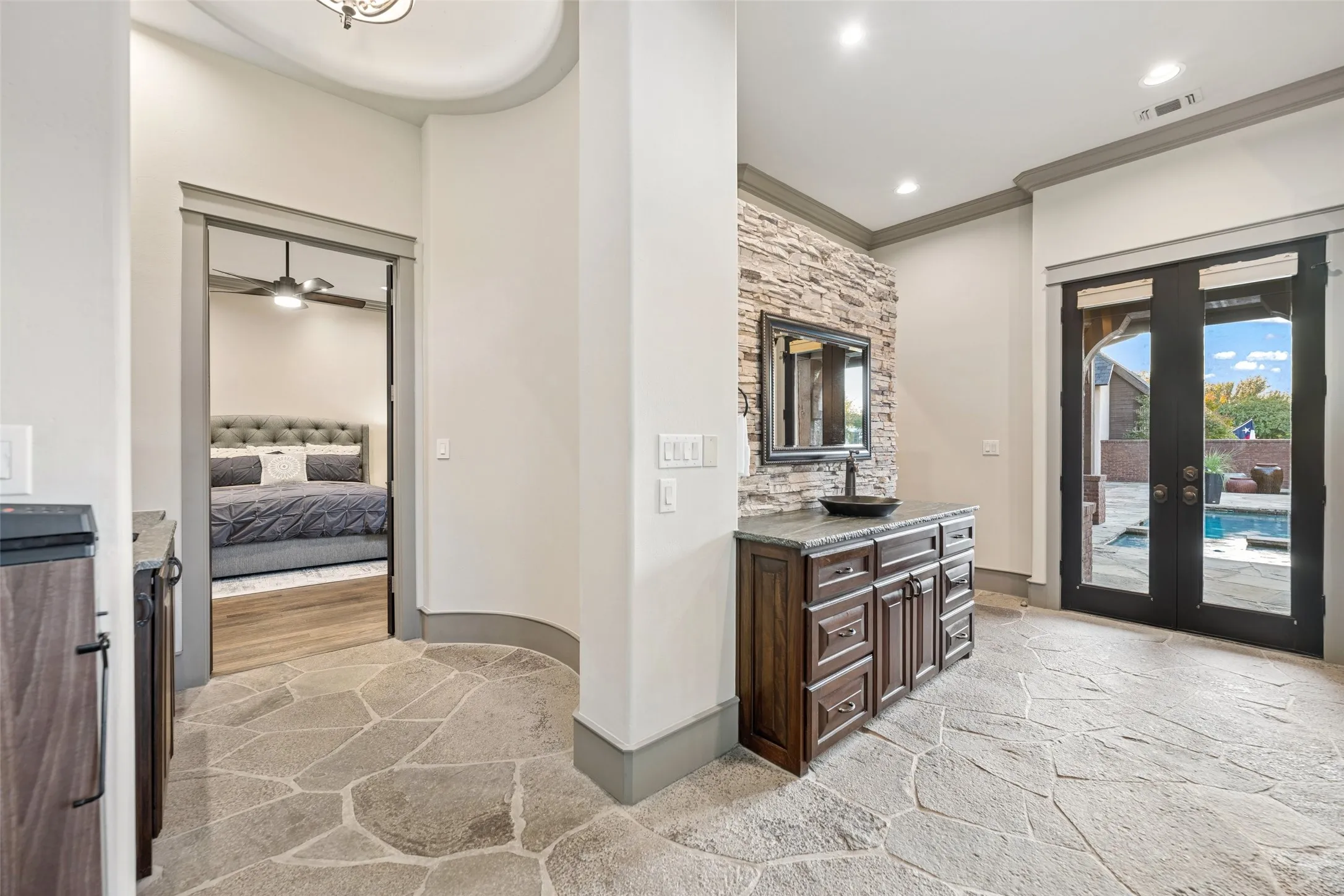 Stunning spa with soaking tub and a coffee bar with stone flooring.