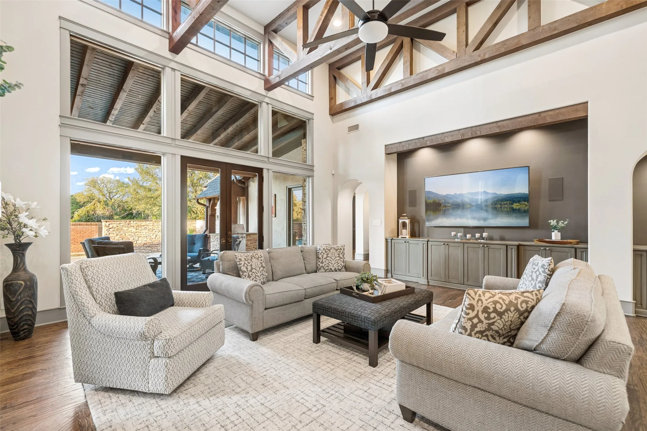 The dedicated media niche features custom recessed cabinetry, accent lighting, and integrated audio surround.