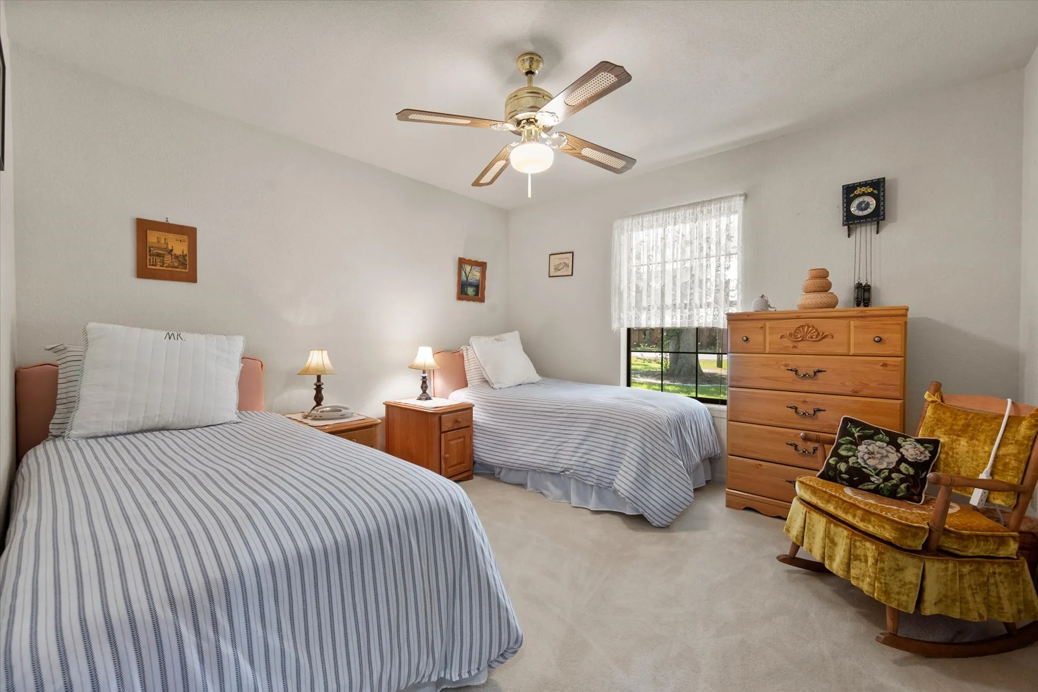 Neutral wall colors, ceiling fan with integrated lighting, window with privacy coverings, and carpeted flooring