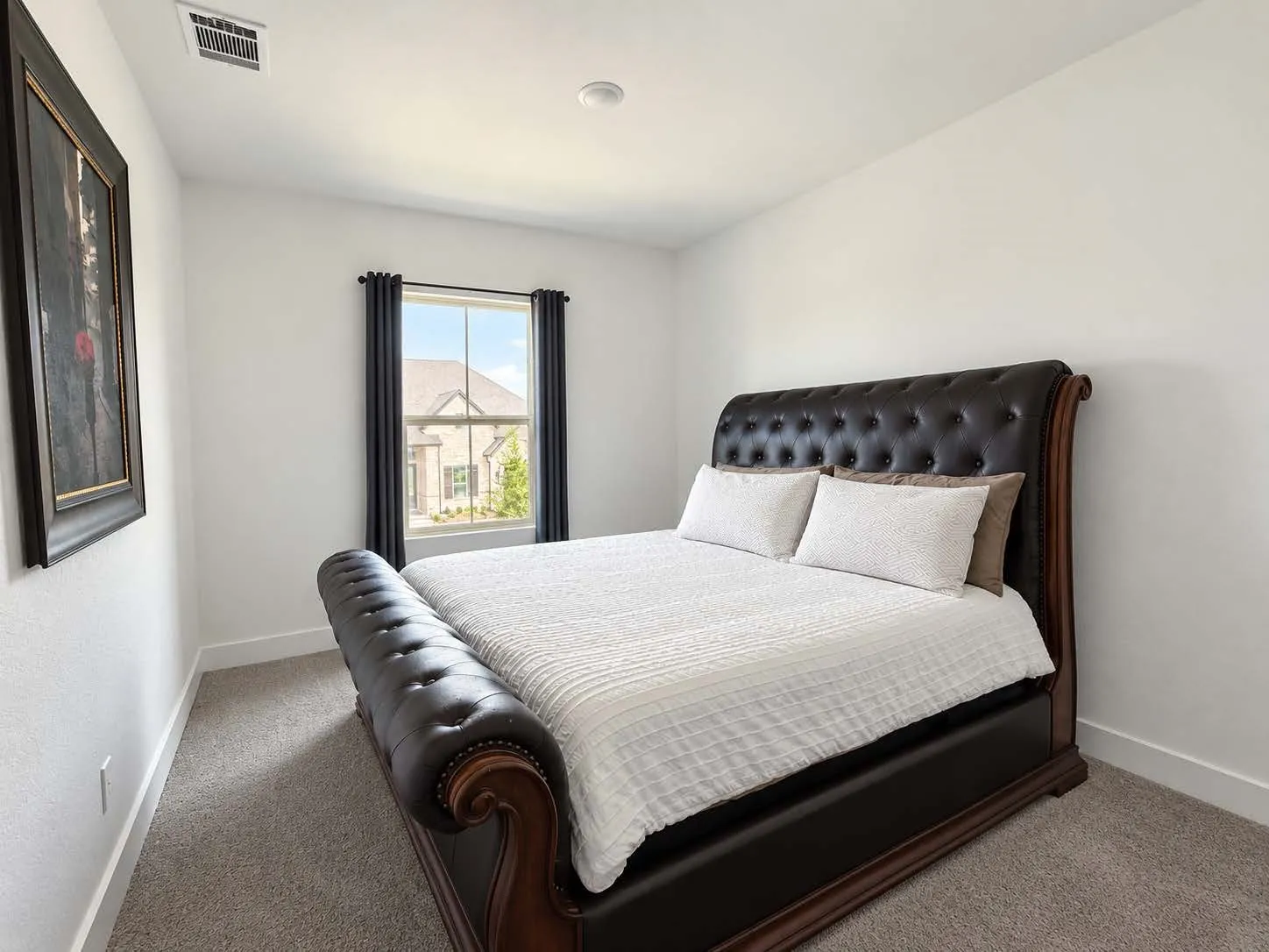 Recessed lighting, neutral wall paint, carpeted flooring, and a single window