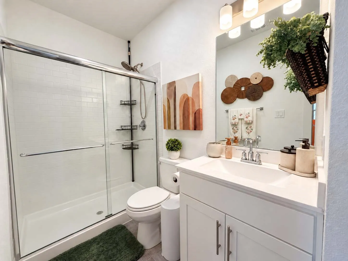 White vanity with an integrated sink, polished chrome faucet, and storage cabinetry